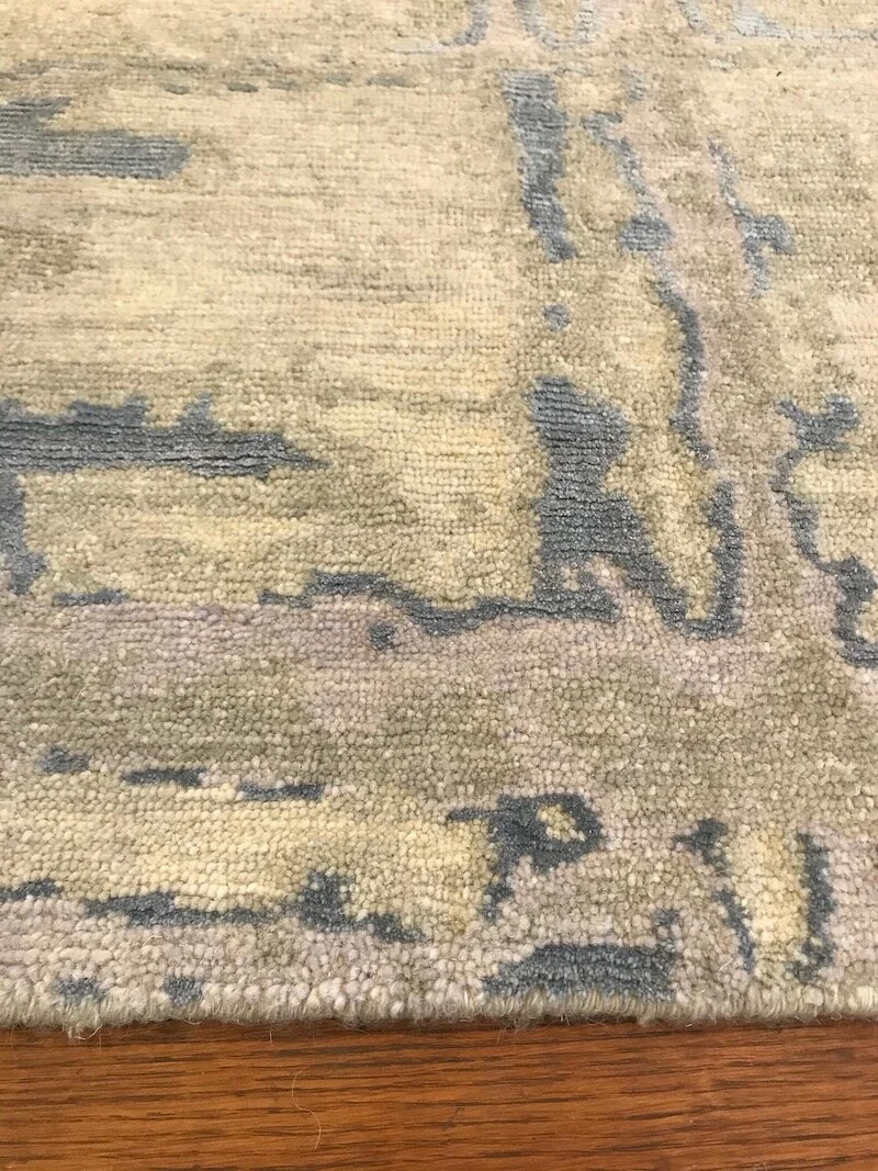 Close-up of a patterned area rug on a wooden floor