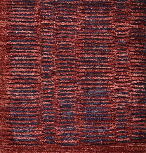 Close-up of a textured red and dark blue striped carpet.