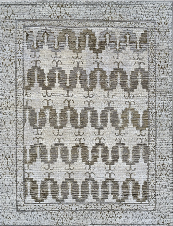 A patterned area rug with geometric design in beige, brown, and cream colors.