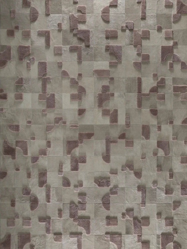 Decorative wall with 3D geometric textured tiles in shades of beige and mauve.