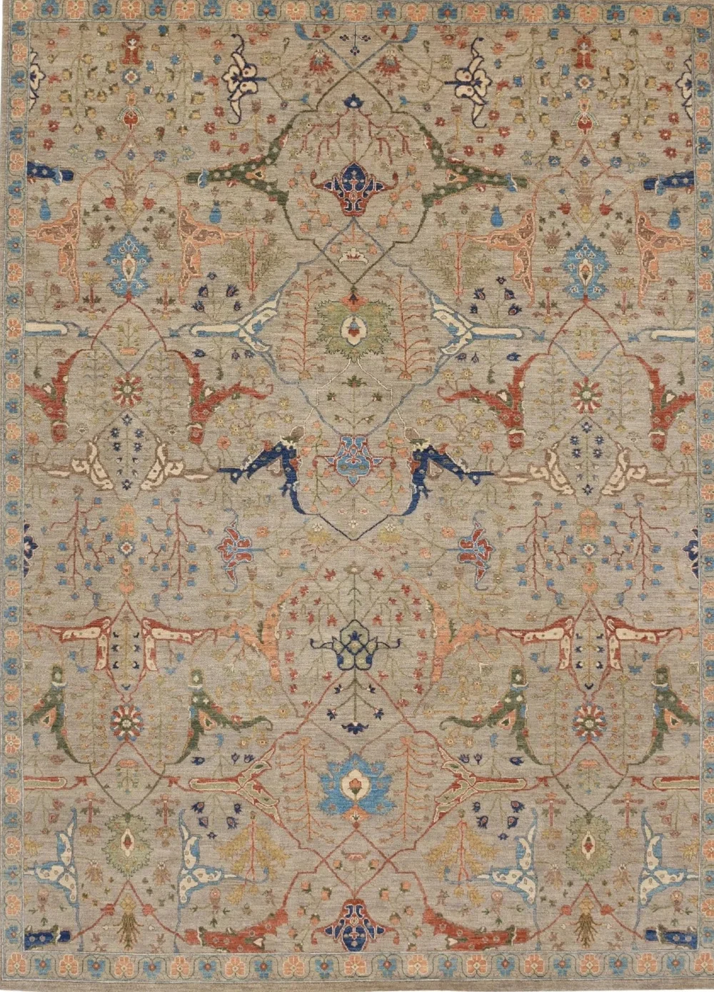 Detailed, ornate area rug with a symmetrical pattern of floral and geometric motifs in pastel shades of beige, peach, blue, red, green, and gold.