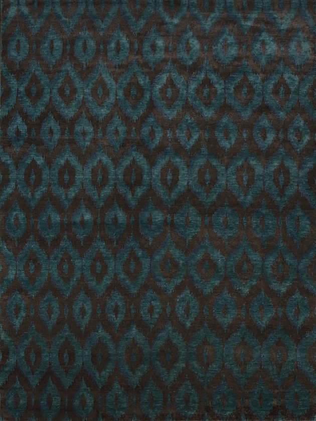 Close-up of fabric with a teal and black geometric diamond pattern.