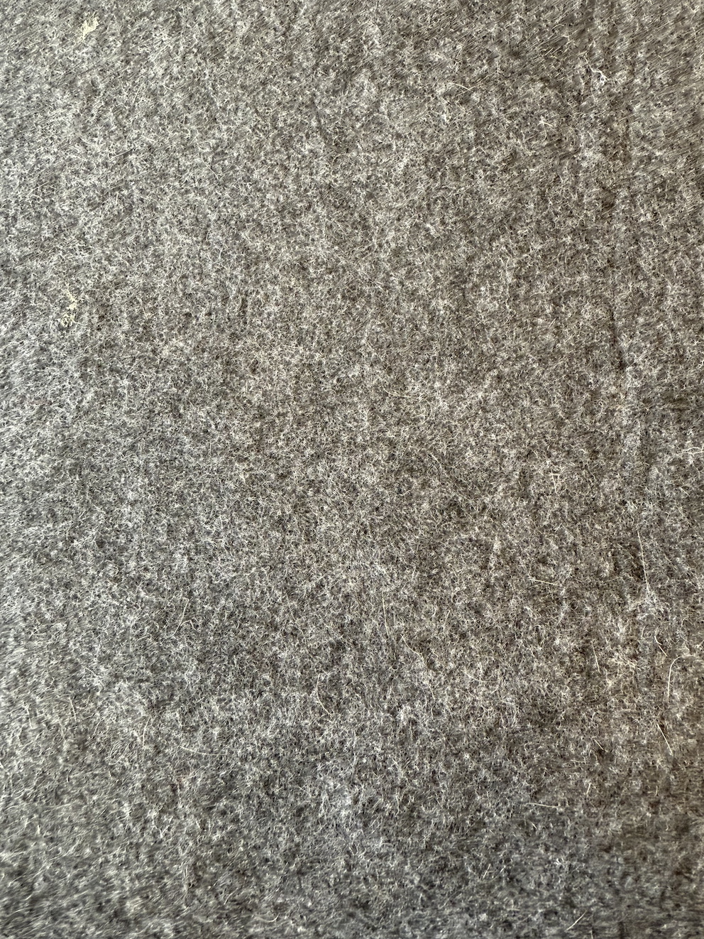 Close-up of gray textured fabric or material surface.