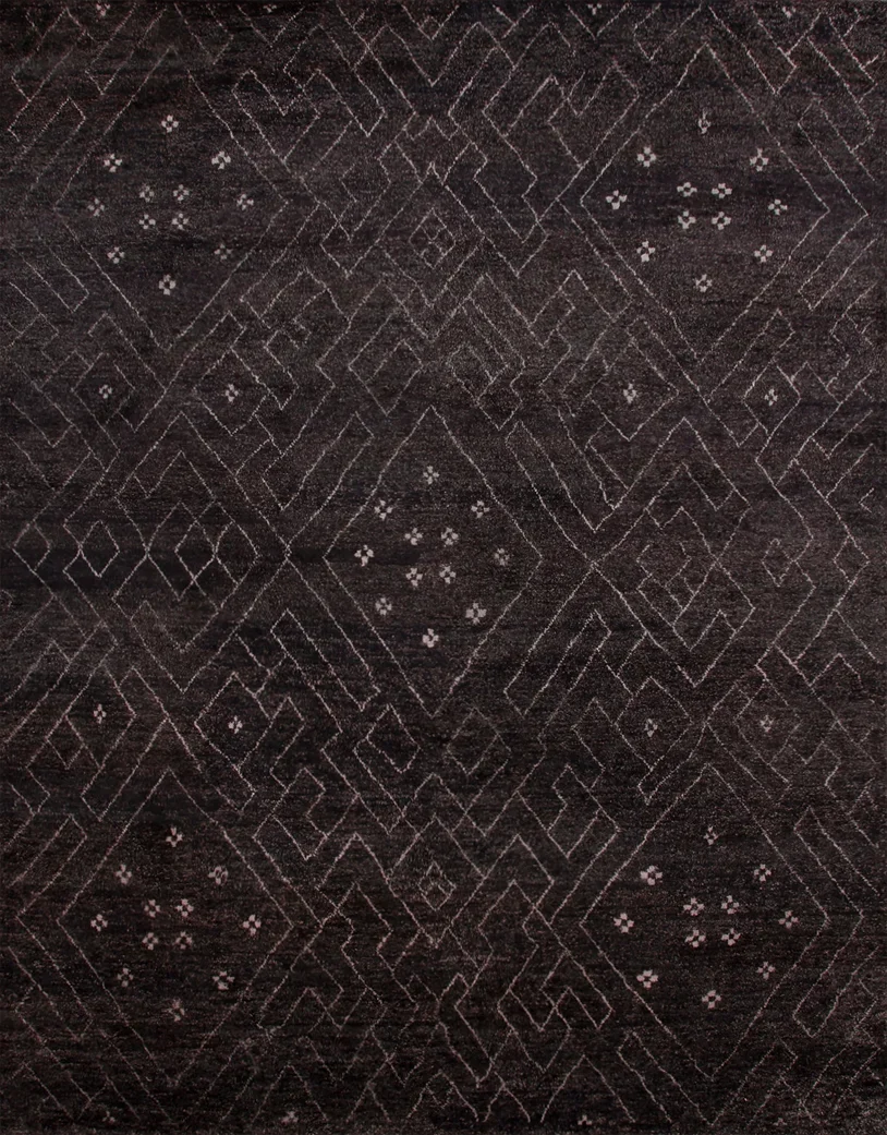 A dark, textured carpet with a geometric pattern of interconnected lines and small floral shapes in a lighter color.