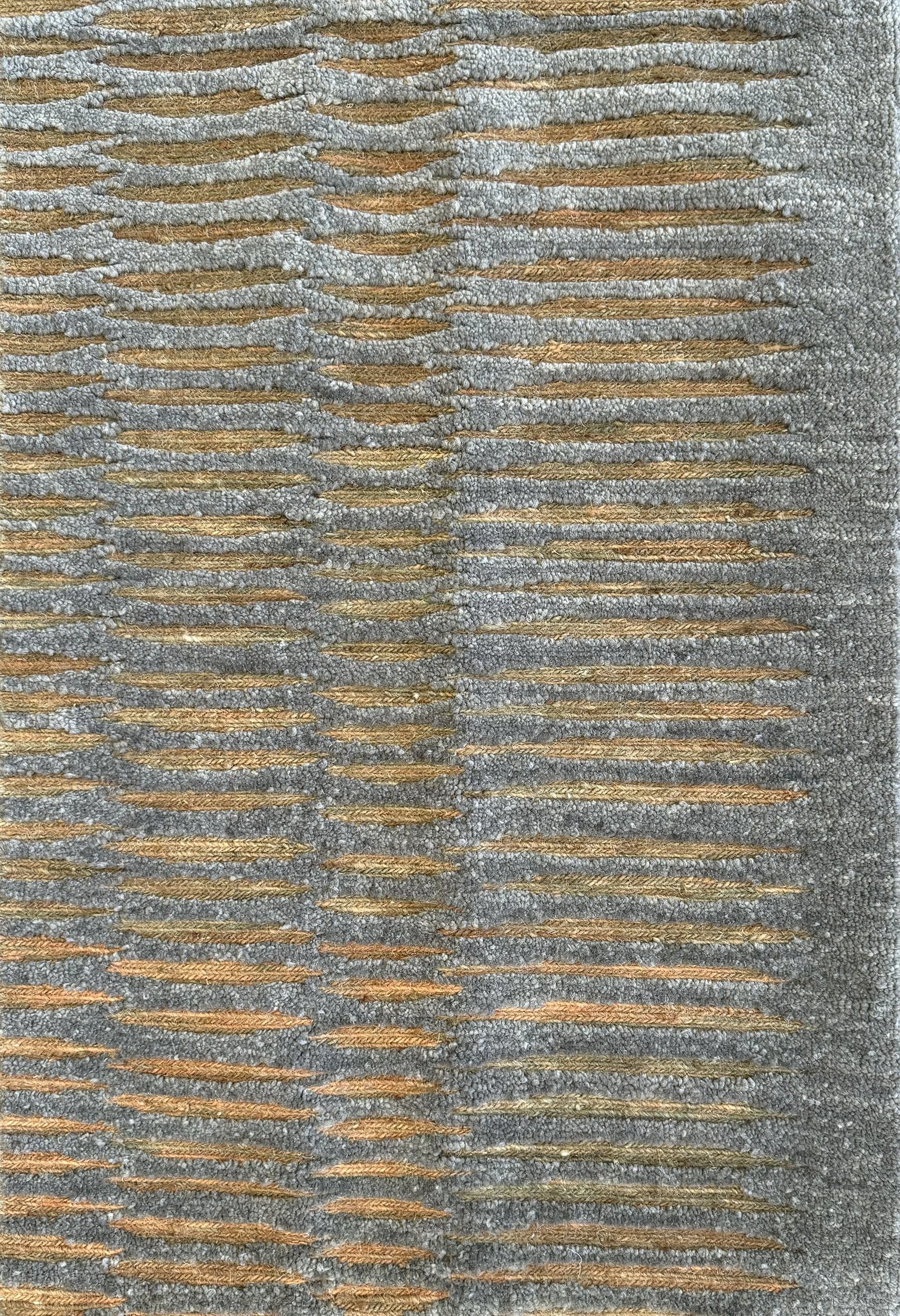 Close-up of a textured, grey rug with a amber stripes