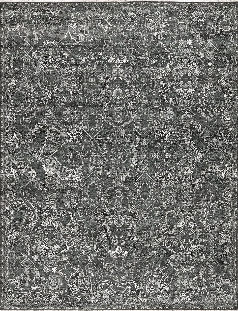 A black and white intricately patterned area rug with symmetrical geometric and floral motifs.