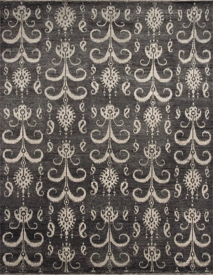 Gray rug with an intricate white floral and scroll pattern.