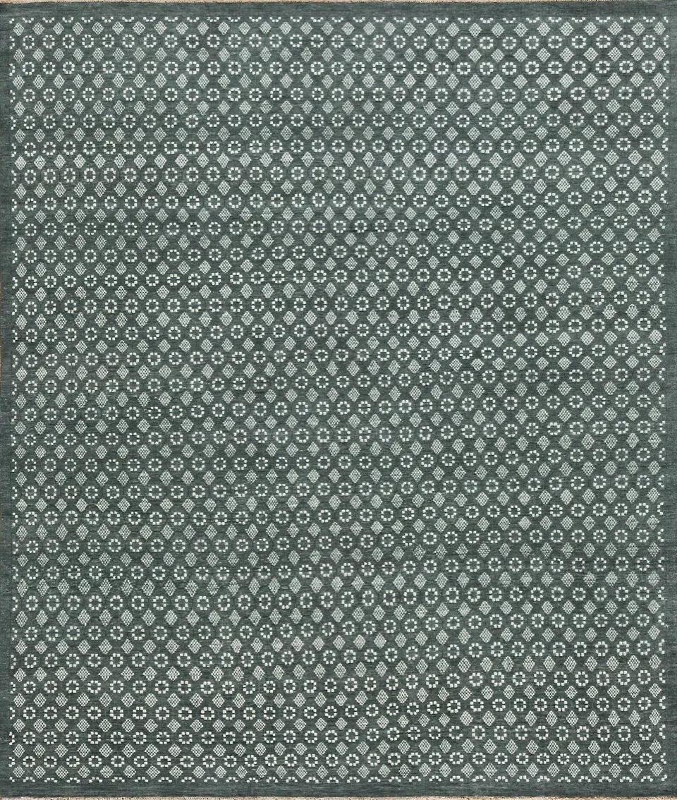 Close-up of a patterned fabric with small, repeating geometric shapes in white and black.