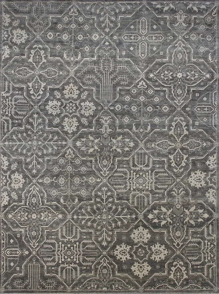 A patterned gray and white rug with intricate geometric and floral designs.