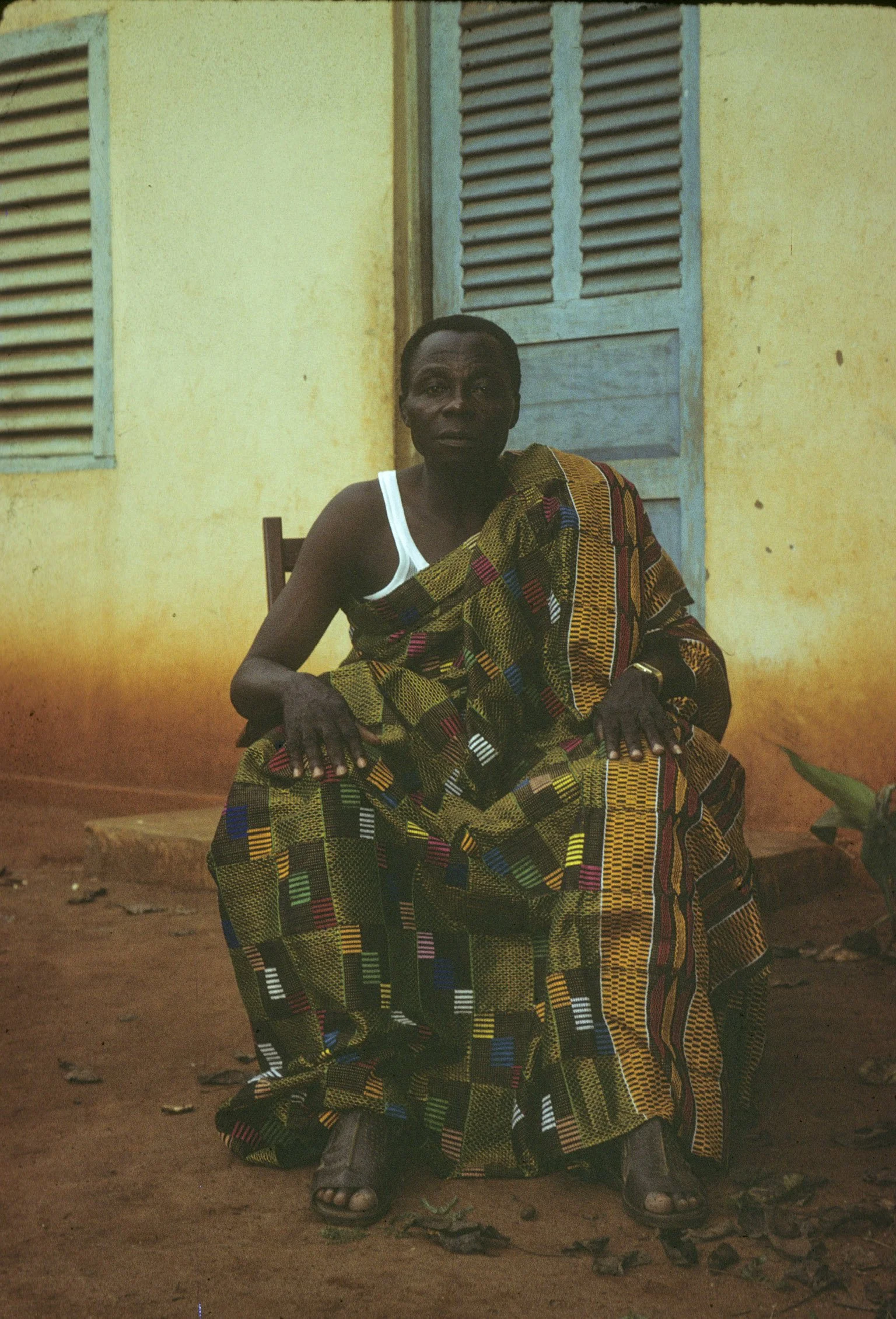 An archival photo of Fofo taken by Elizabeth. He is sitting in front of a building on Dadas' compound in town that he used as his office as mayor. Fofo lives auvillage (in the village) outside of Klouékanmè with his other wives. According to customar