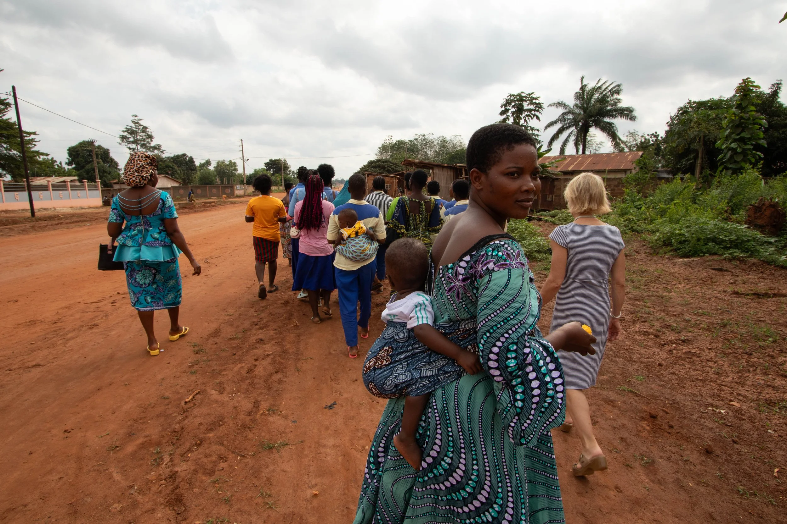 The woman in the foreground is Edah Jolie. She created a space and opportunity for girls to learn how to make clothes and do hair, giving them a chance to work a steady job once they are old enough. Some girls stay with the woman permanently, and oth