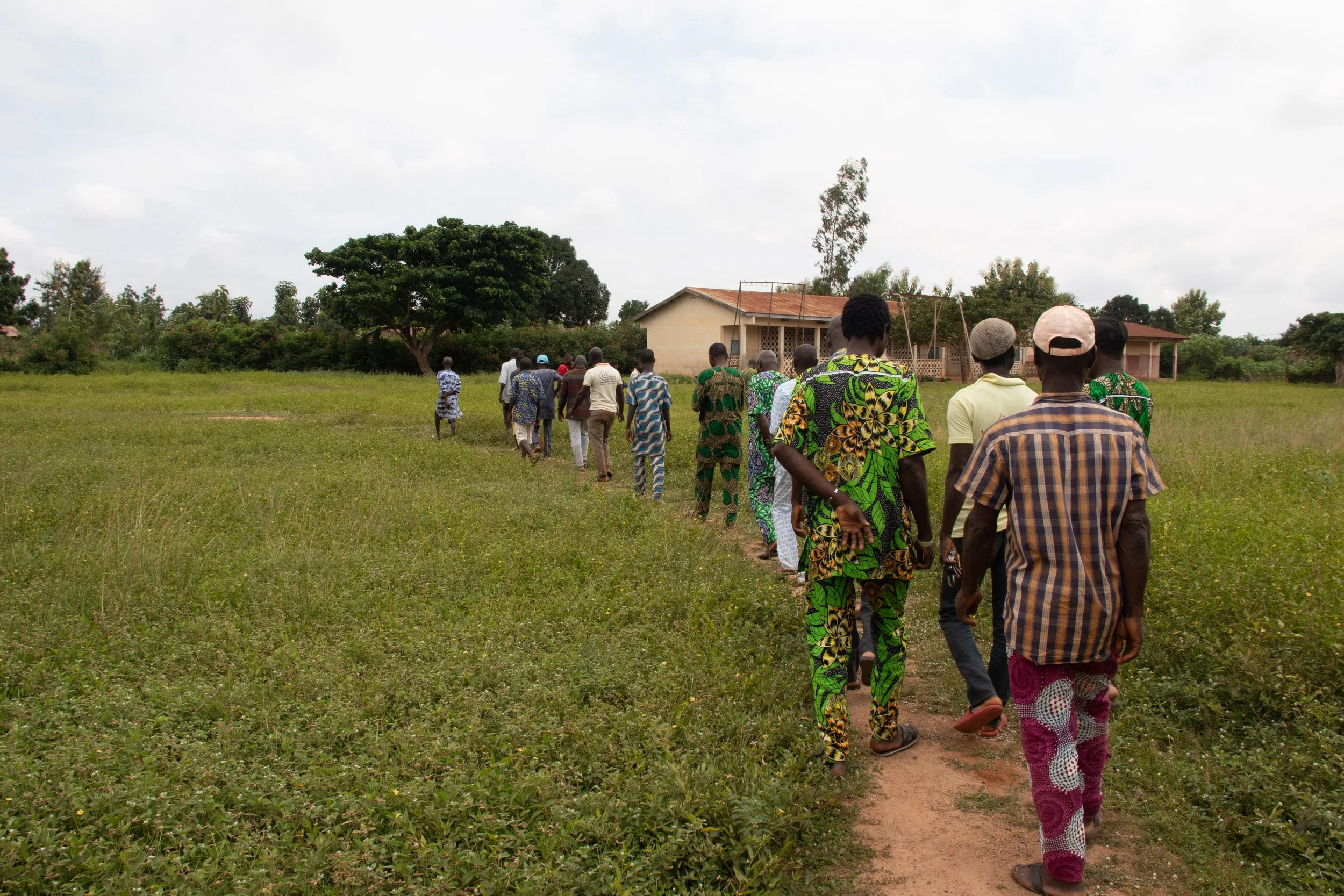 Everyone is walking out to the newest field planted, August 2024.