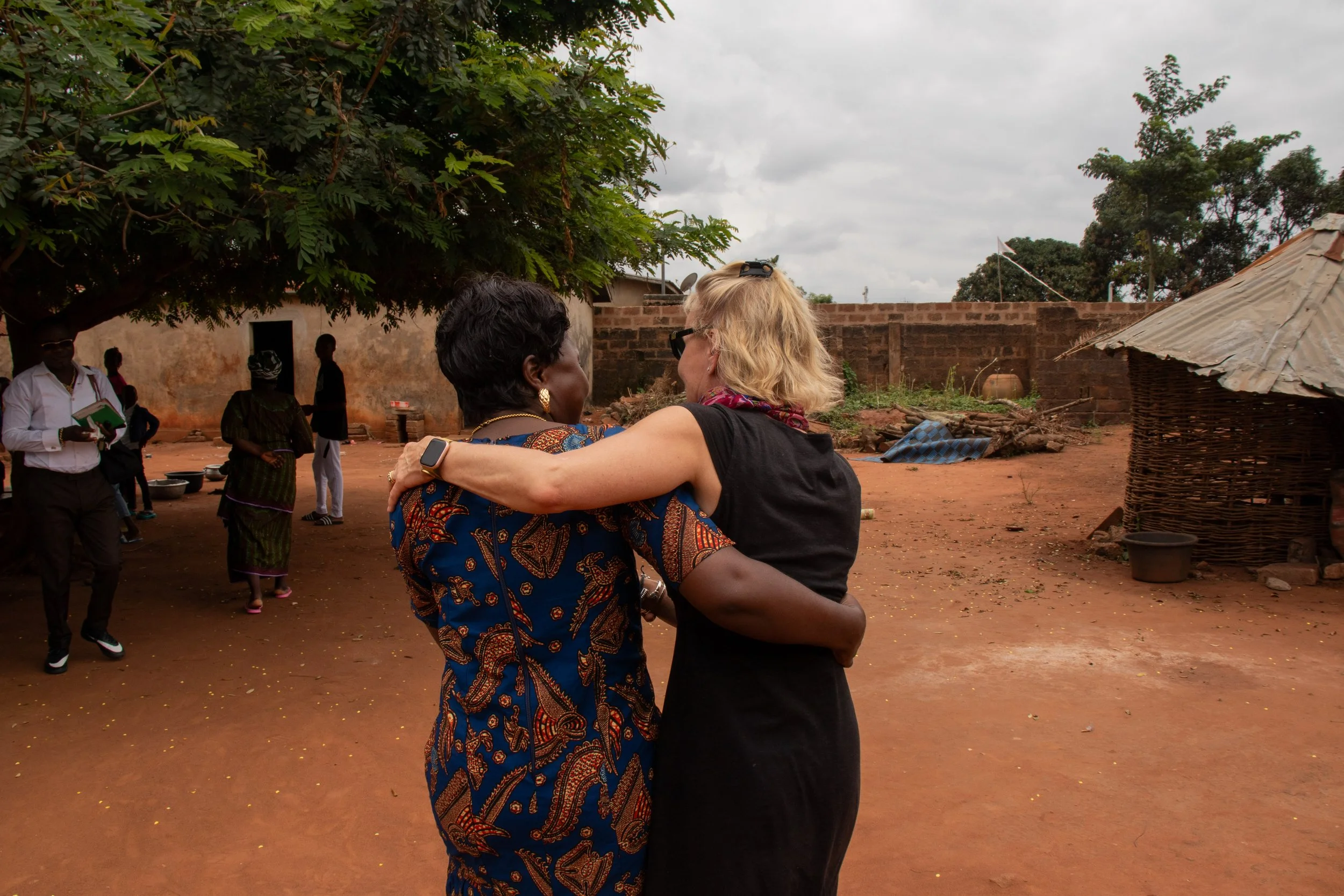 My mother and Jero (daughter to Dad) walking into Dada’s house for the first time in 34 years, August 2024. 
