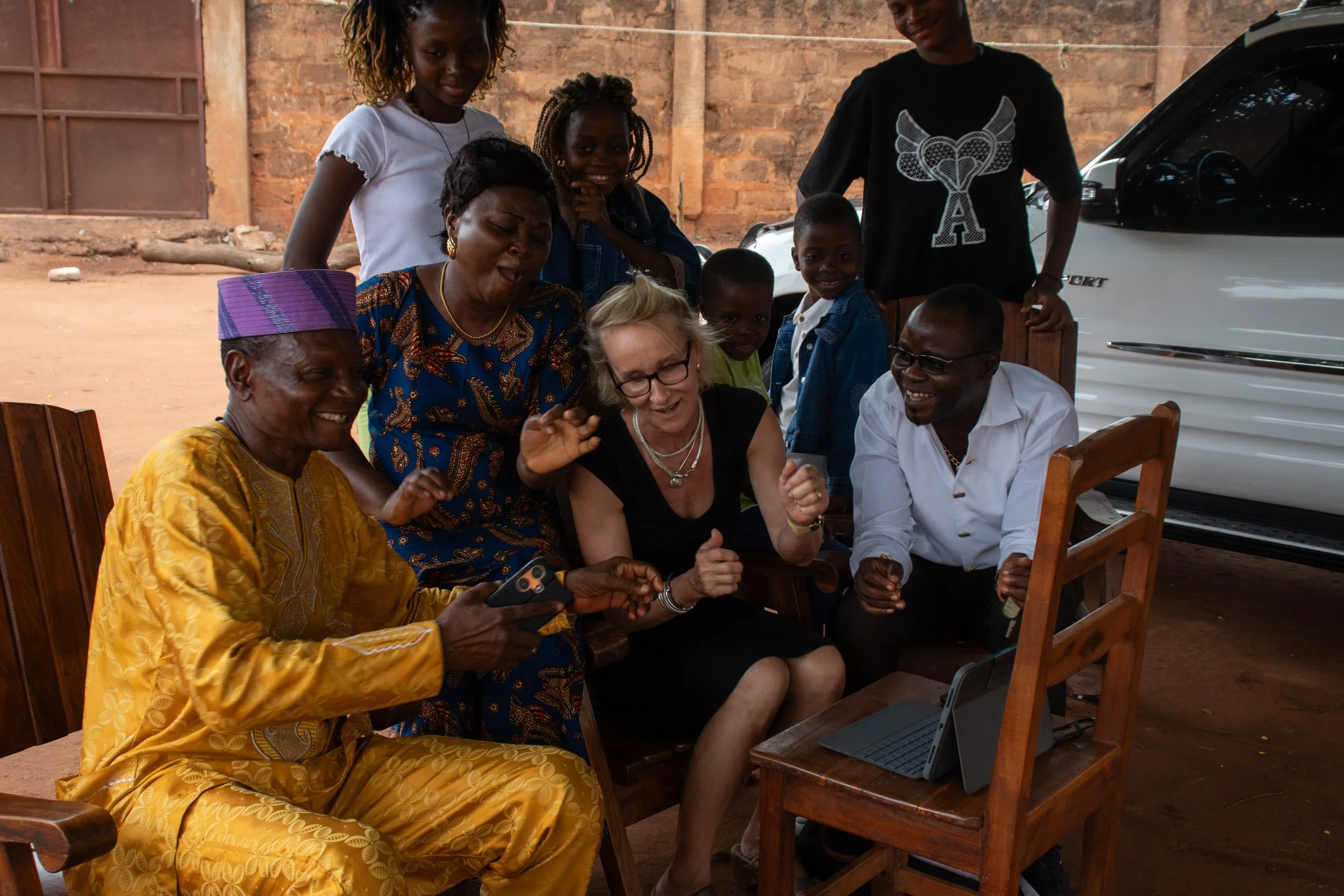 Two of Dada's children, with whom my mother lived with now grown. Older sister Jero (left) and younger brother Assani (right) are looking at old photos my mother took and recalling the songs my mother taught them, August 2024. 