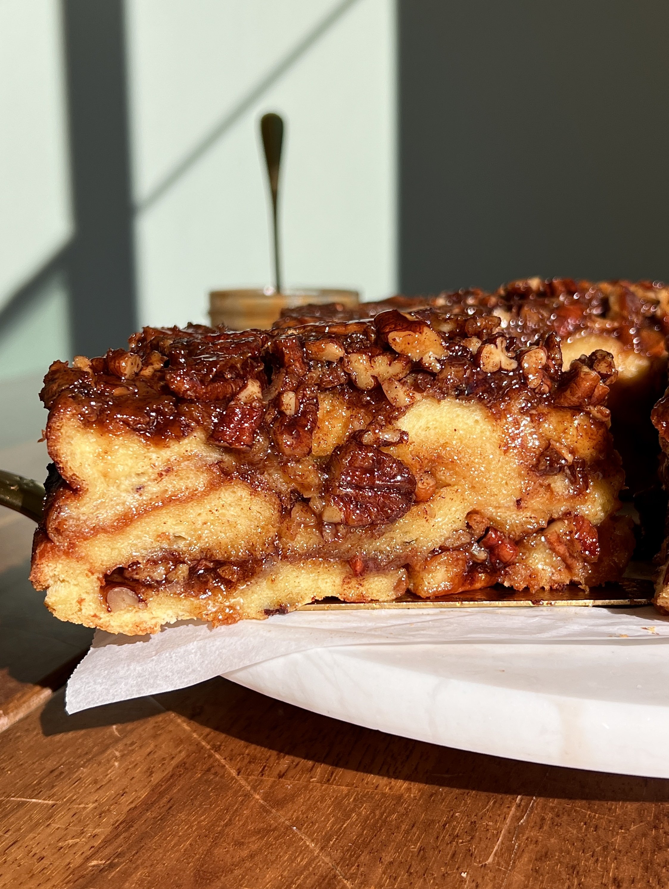 Close-up of pecan sticky bun bread pudding showing custardy brioche layers and sticky pecan filling.