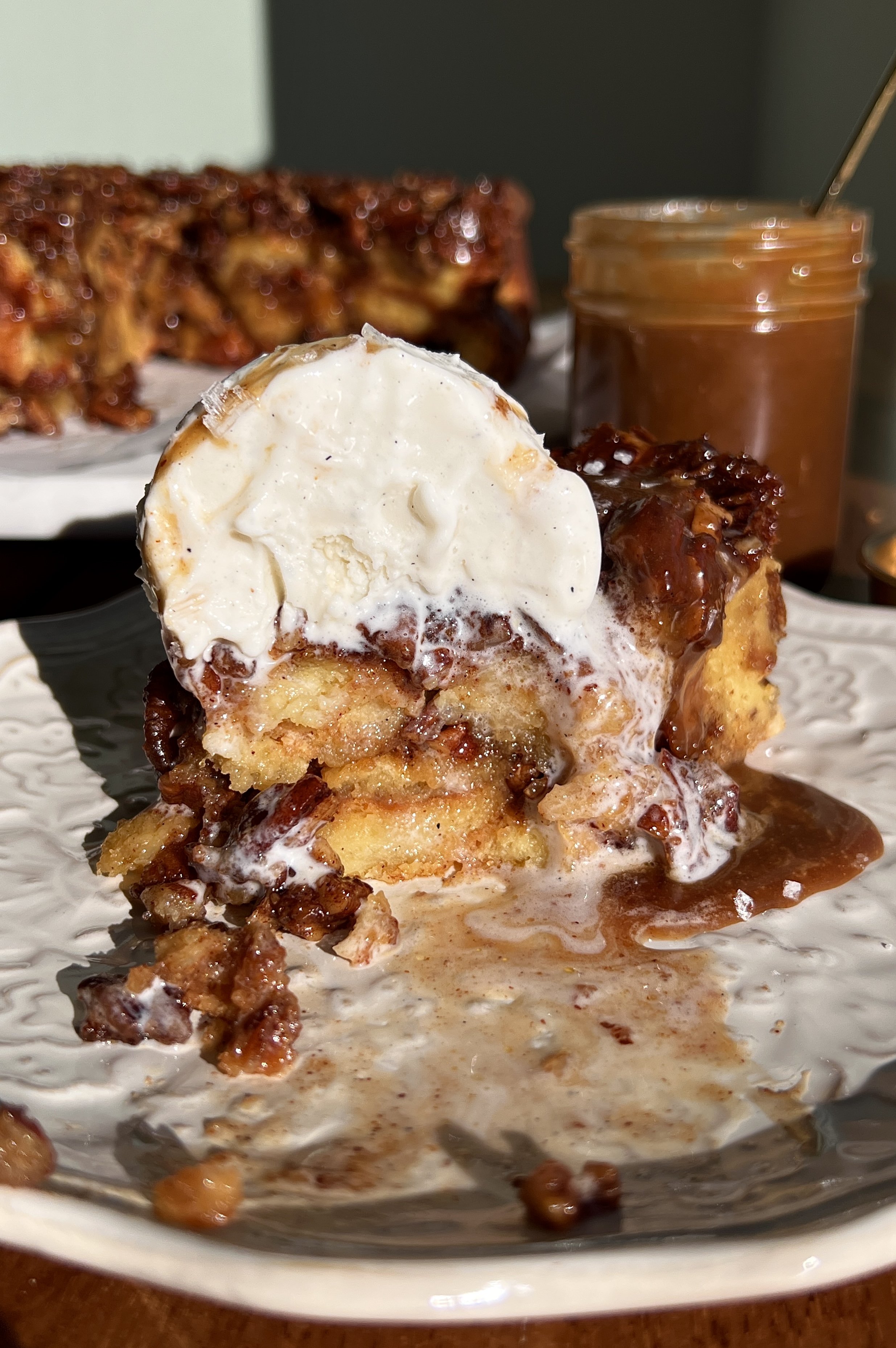 Pecan sticky bun bread pudding served warm with vanilla ice cream and flaky sea salt.