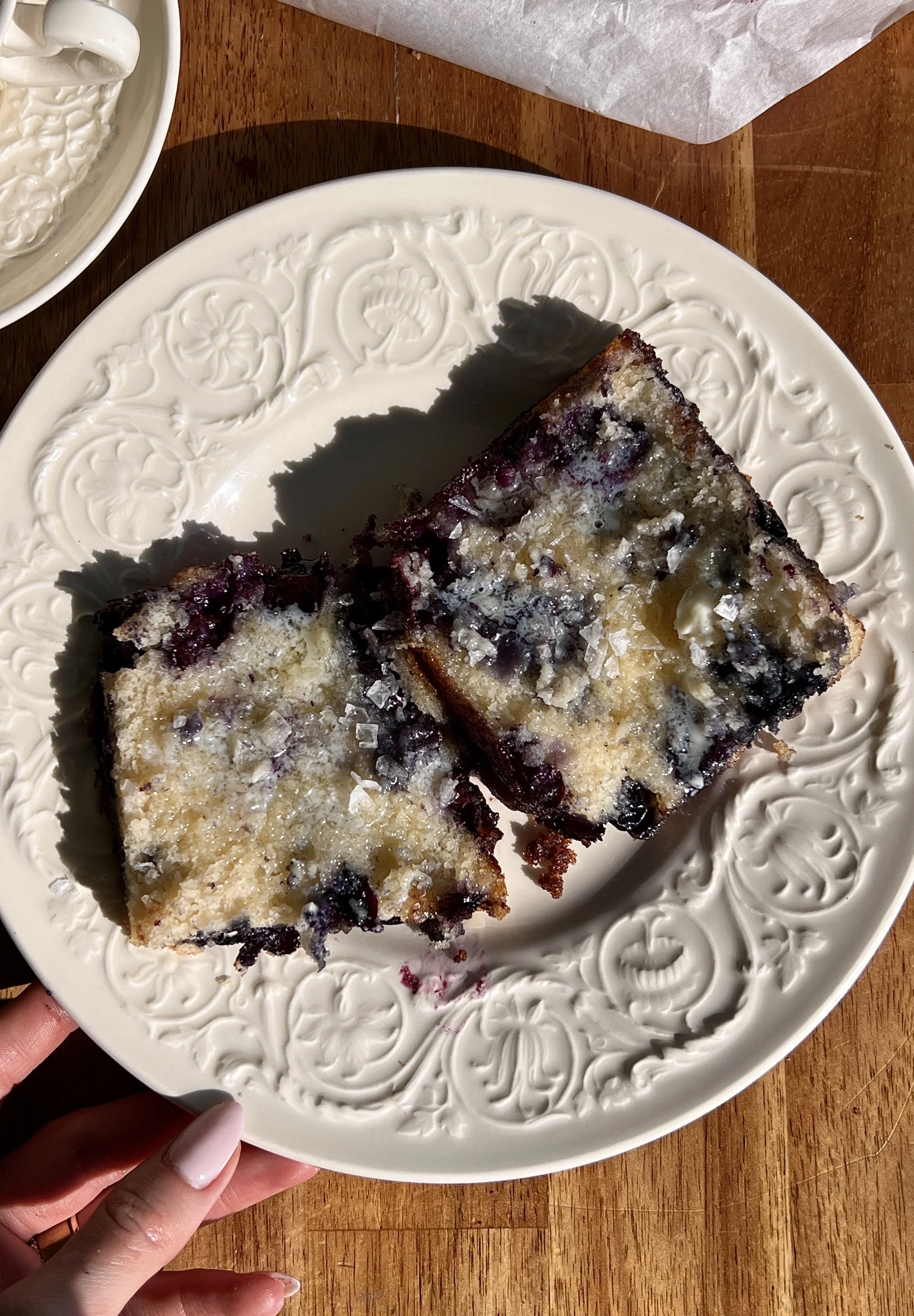 Warm cinnamon crunch blueberry butter swim biscuits served with butter, flaky sea salt, and coffee.