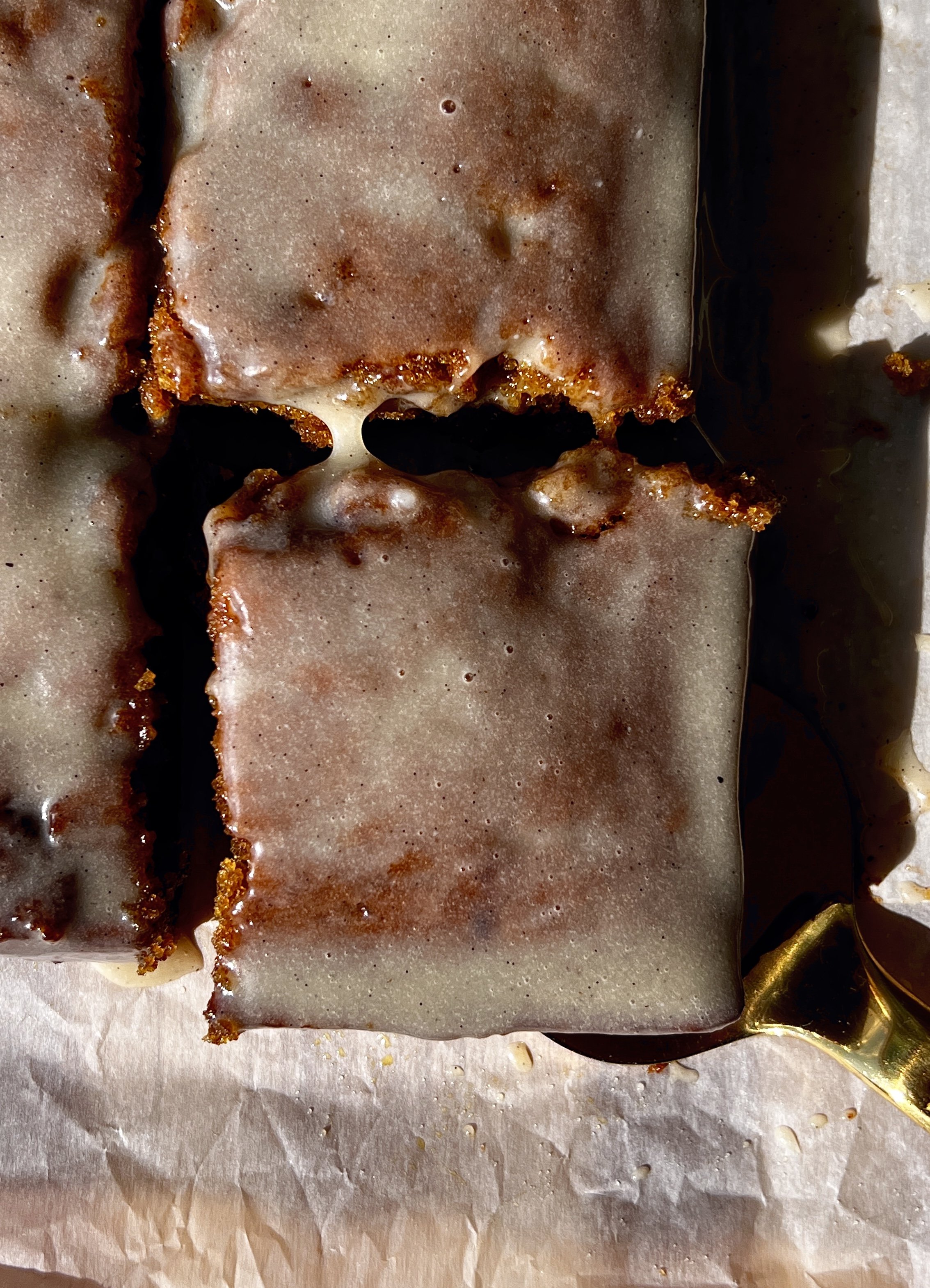 Slice of pumpkin honey bun cake showing the soft tender spiced pumpkin crumb with a cinnamon brown sugar swirl throughout and a honey cream cheese glaze blanket melting over the top.