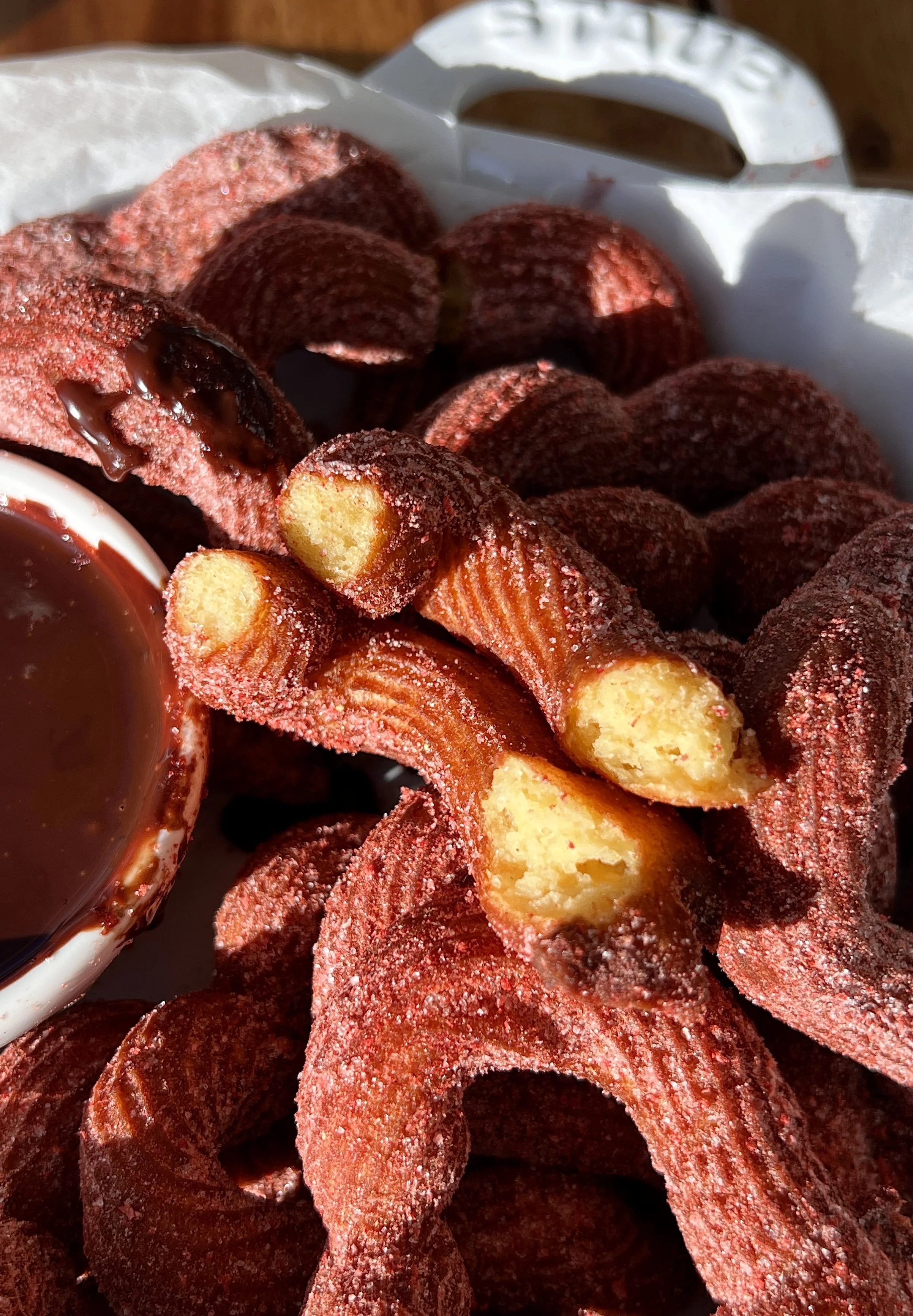 Warm heart churros for Valentine’s Day served with a rich homemade chocolate dipping sauce.