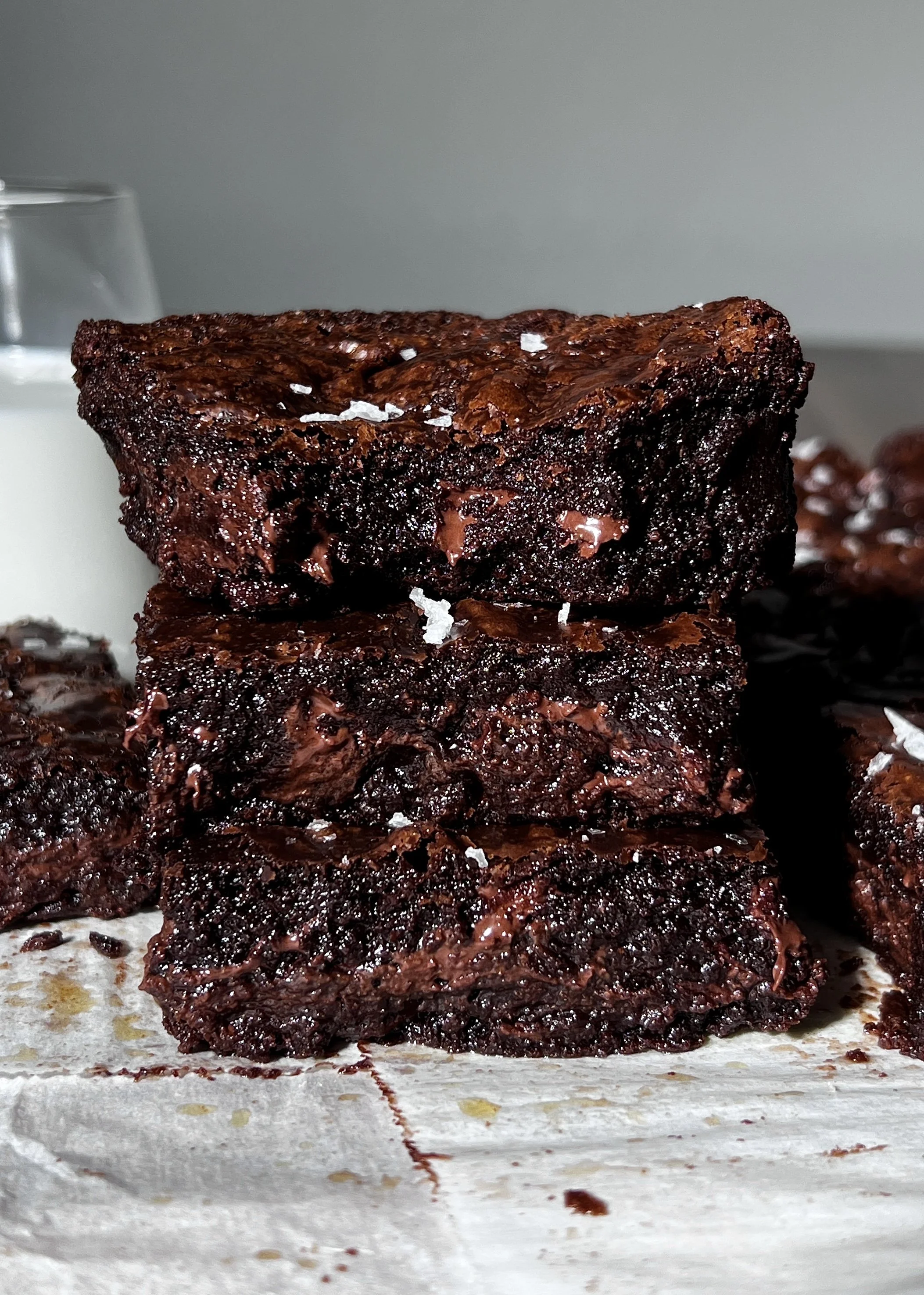 Fudgy crinkle-top brown butter brownies with a shiny crackled top, melty chocolate chips, and flaky sea salt.
