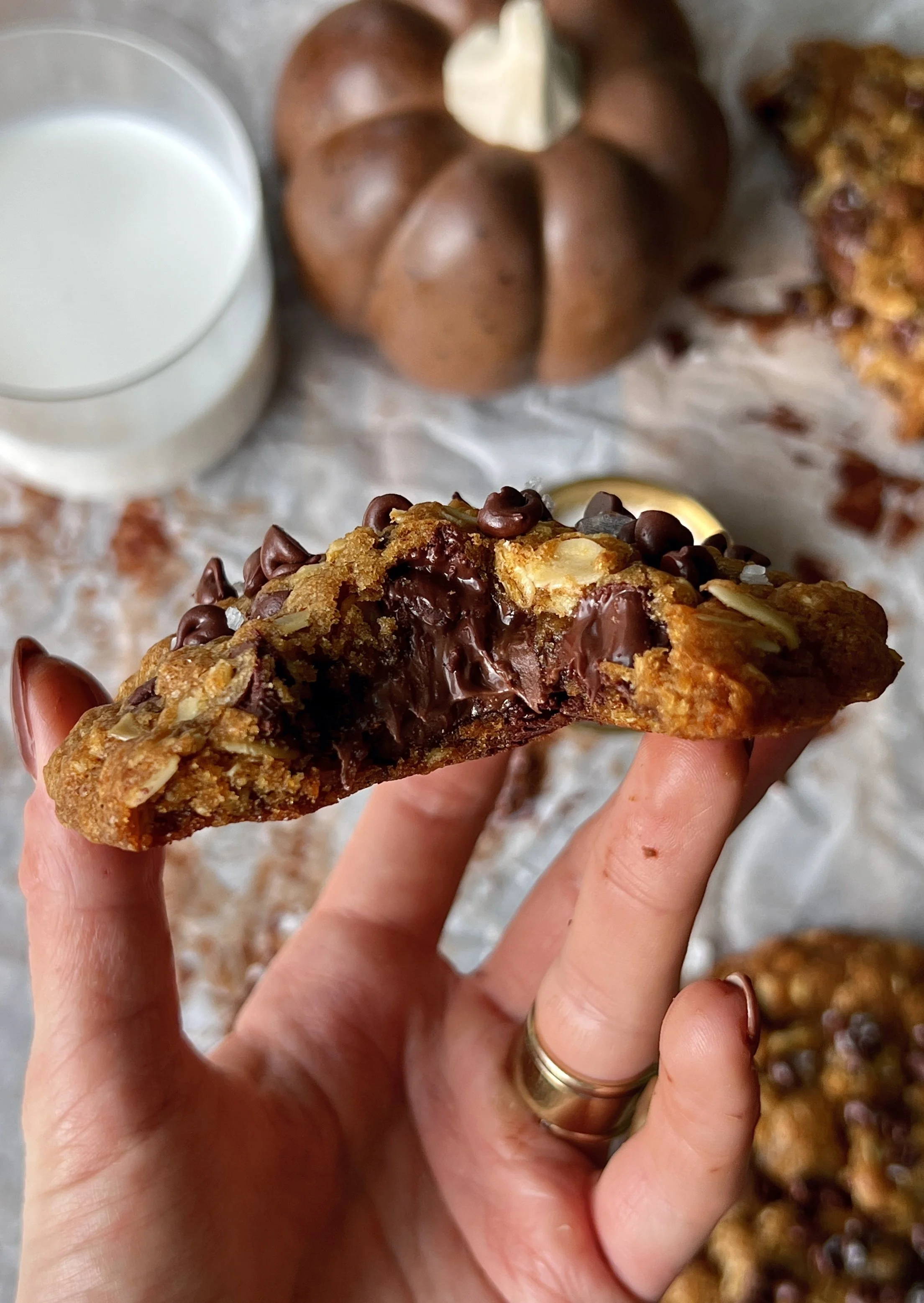 Soft and gooey Nutella stuffed pumpkin oatmeal cookies with brown butter perfectly crisp golden edges melty chocolate chips and a gooey Nutella center served warm with a sprinkle of flaky sea salt and a cold glass of milk.