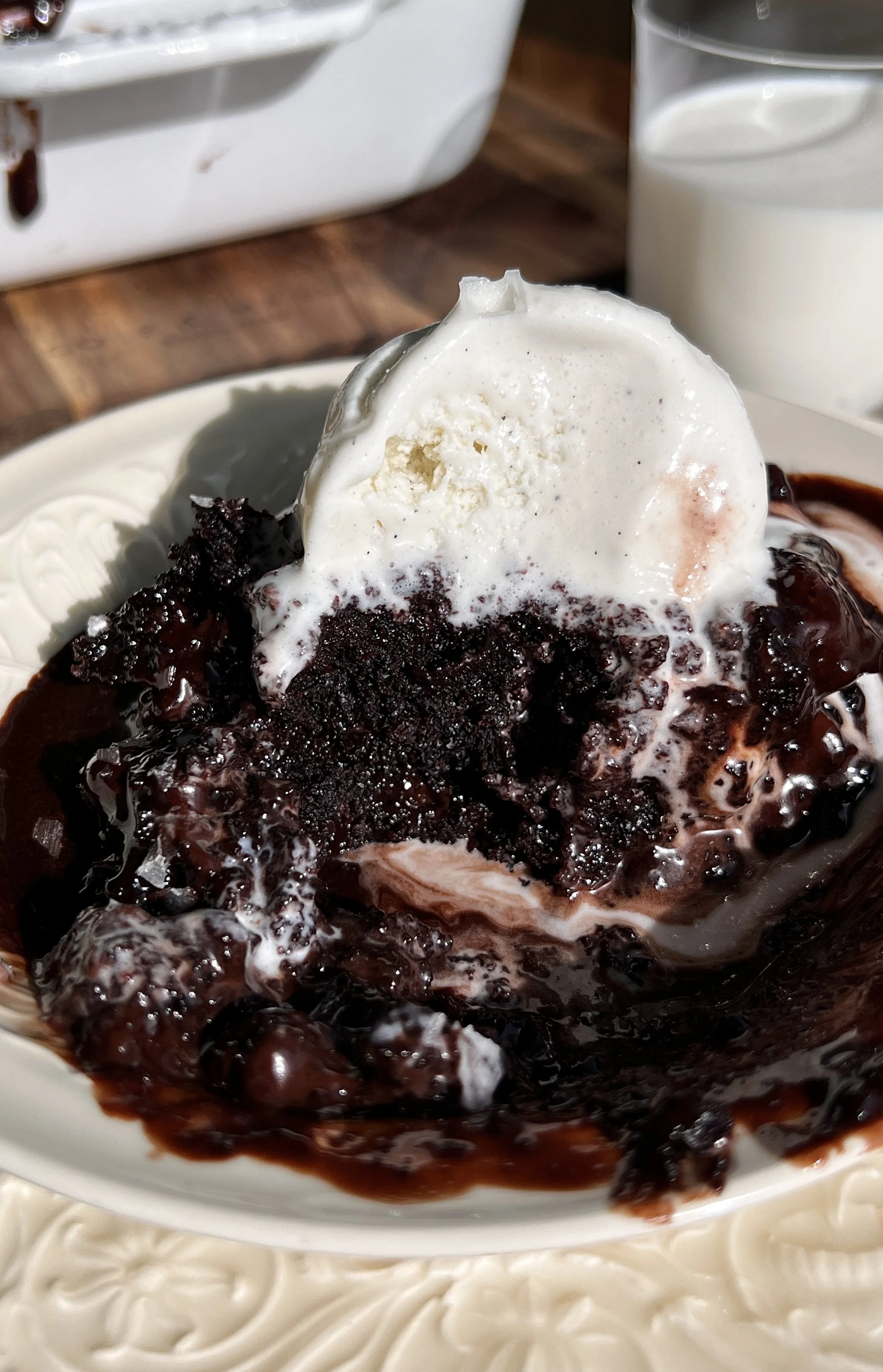 Warm hot chocolate fudge cake served with chocolate ganache, vanilla ice cream, and flaky sea salt.