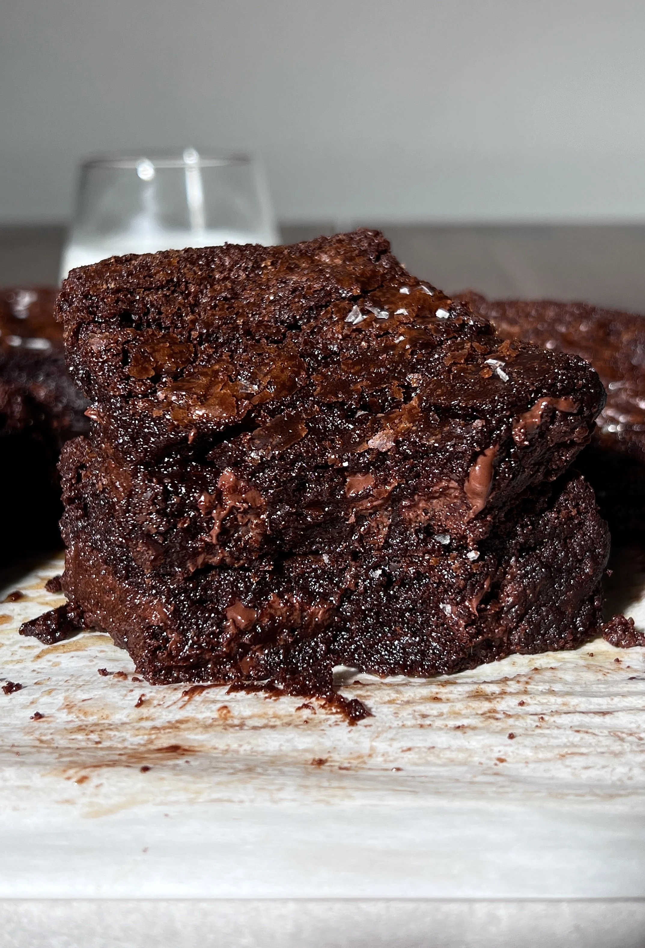 Stack of fudgy crinkle-top brown butter brownies with brown butter, espresso-enhanced chocolate, and flaky sea salt.