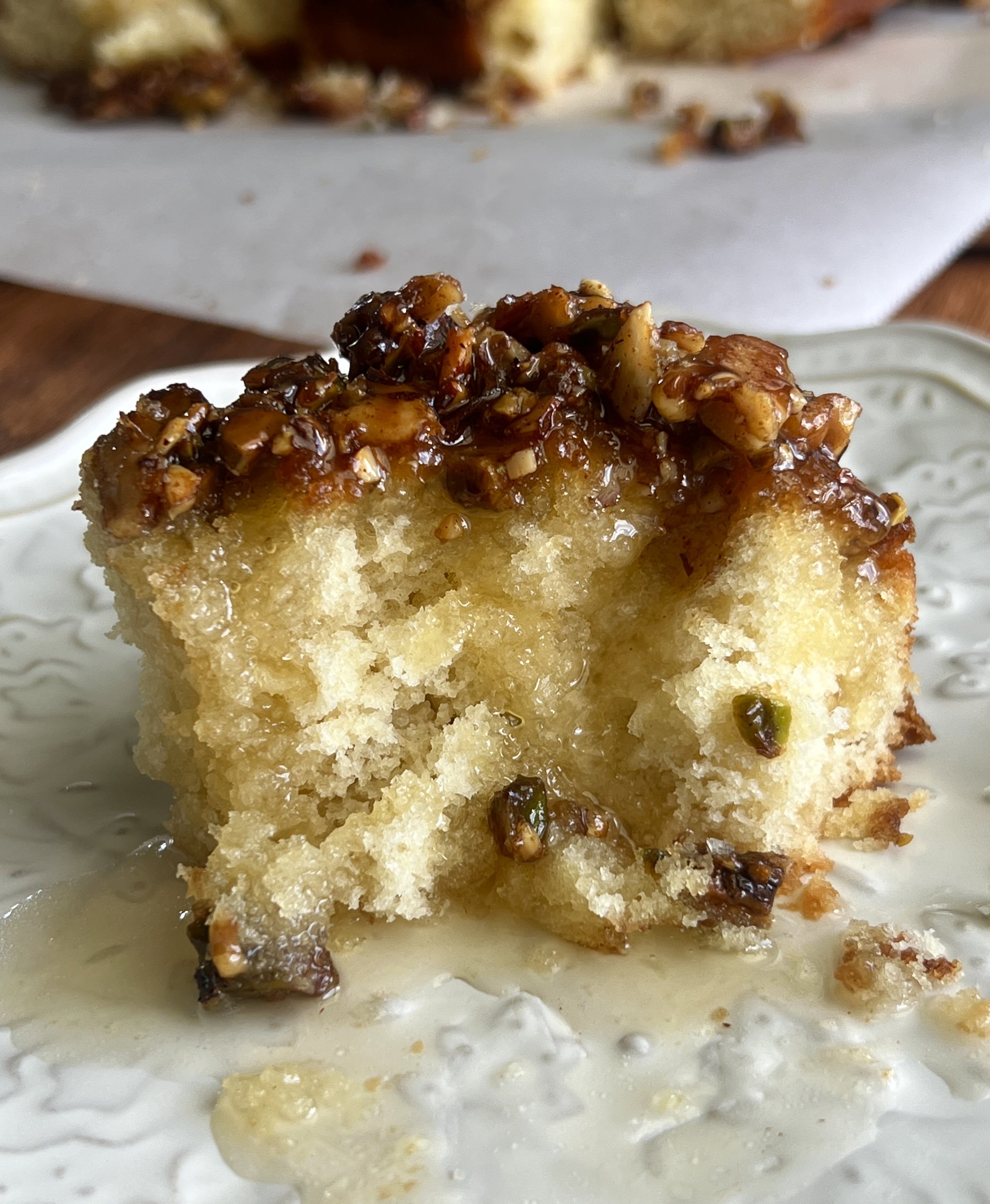 Honey-soaked baklava cake with a crunchy baklava topping, drenched in rich honey syrup.