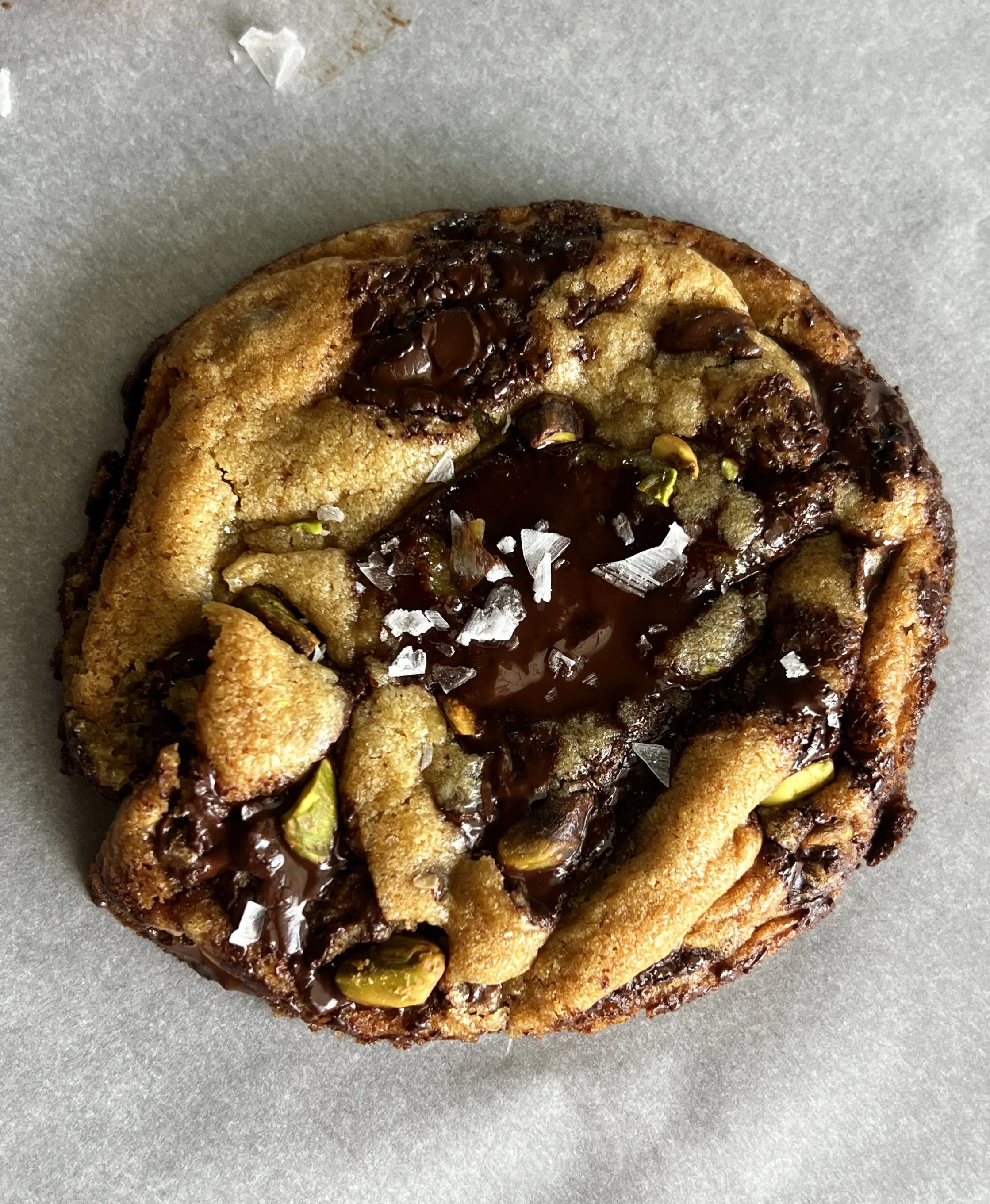 Brown butter pistachio chocolate chip cookies made with rich brown butter chocolate chip cookie dough and filled with smooth pistachio cream.