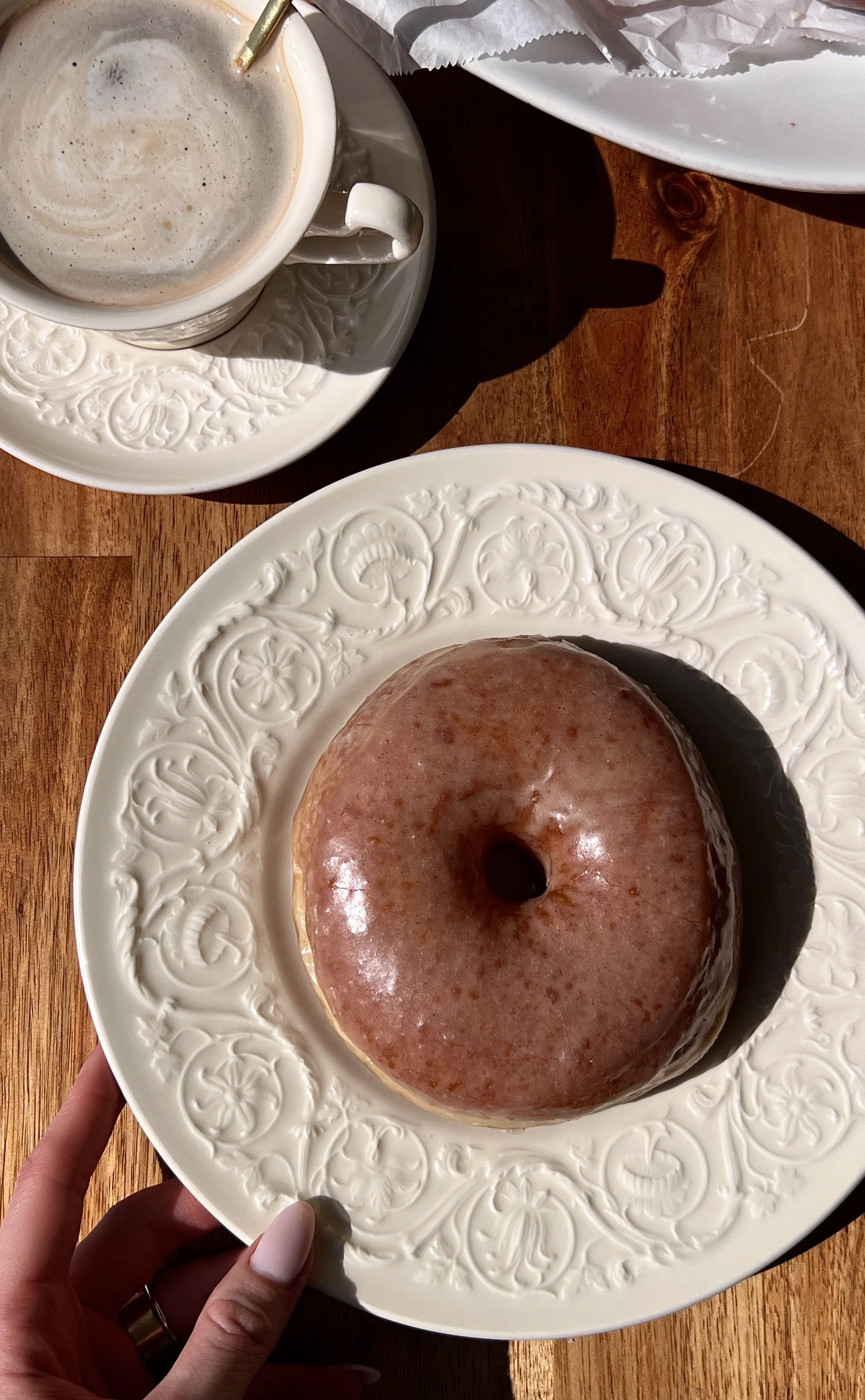 Incredibly soft and fluffy sourdough Krispy Kreme donuts with a beautifully golden slightly chewy exterior coated in a silky crackly vanilla bean or strawberry glaze served warm with a hot cup of coffee.