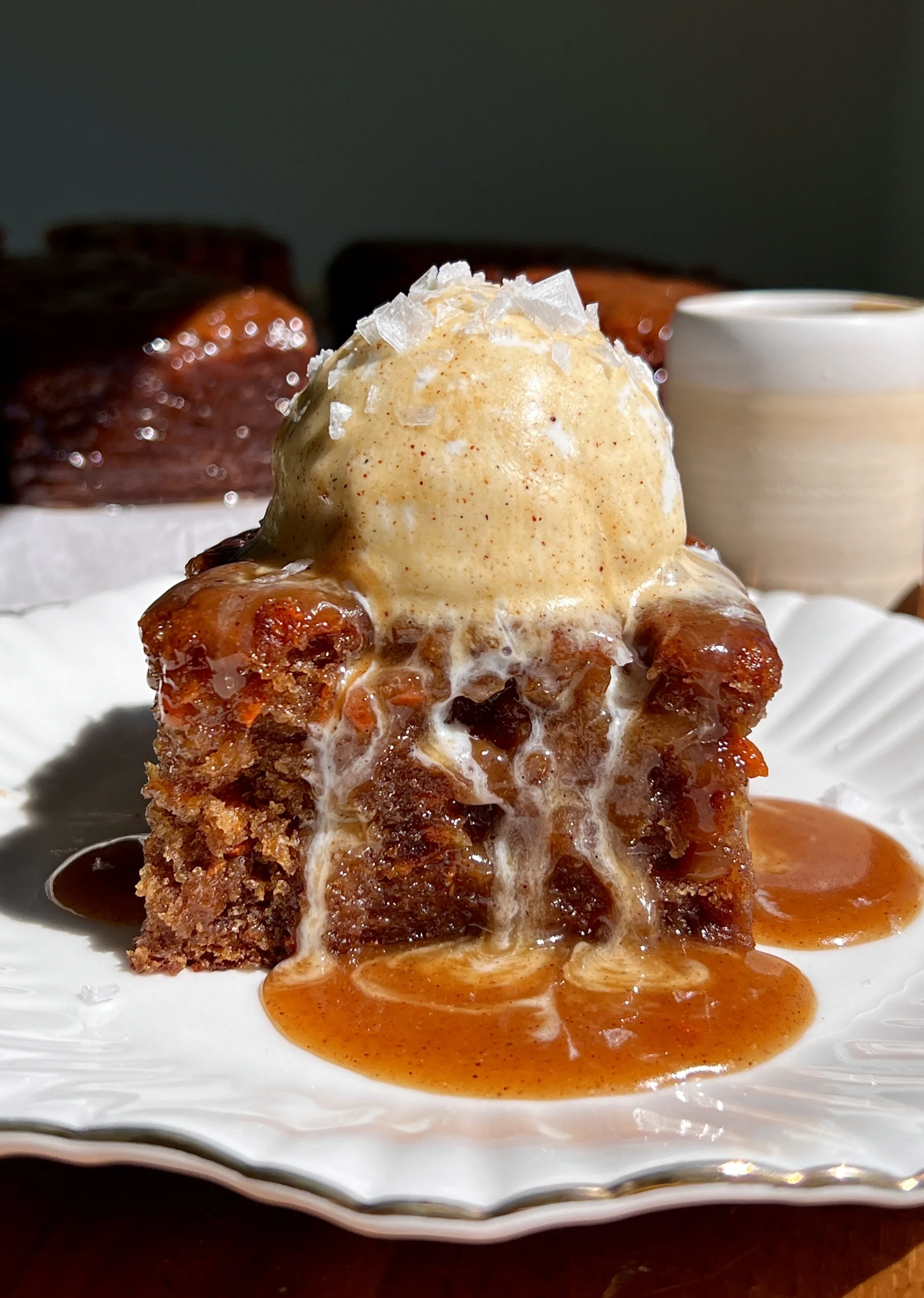 Carrot cake sticky toffee pudding served warm with vanilla ice cream and flaky sea salt.