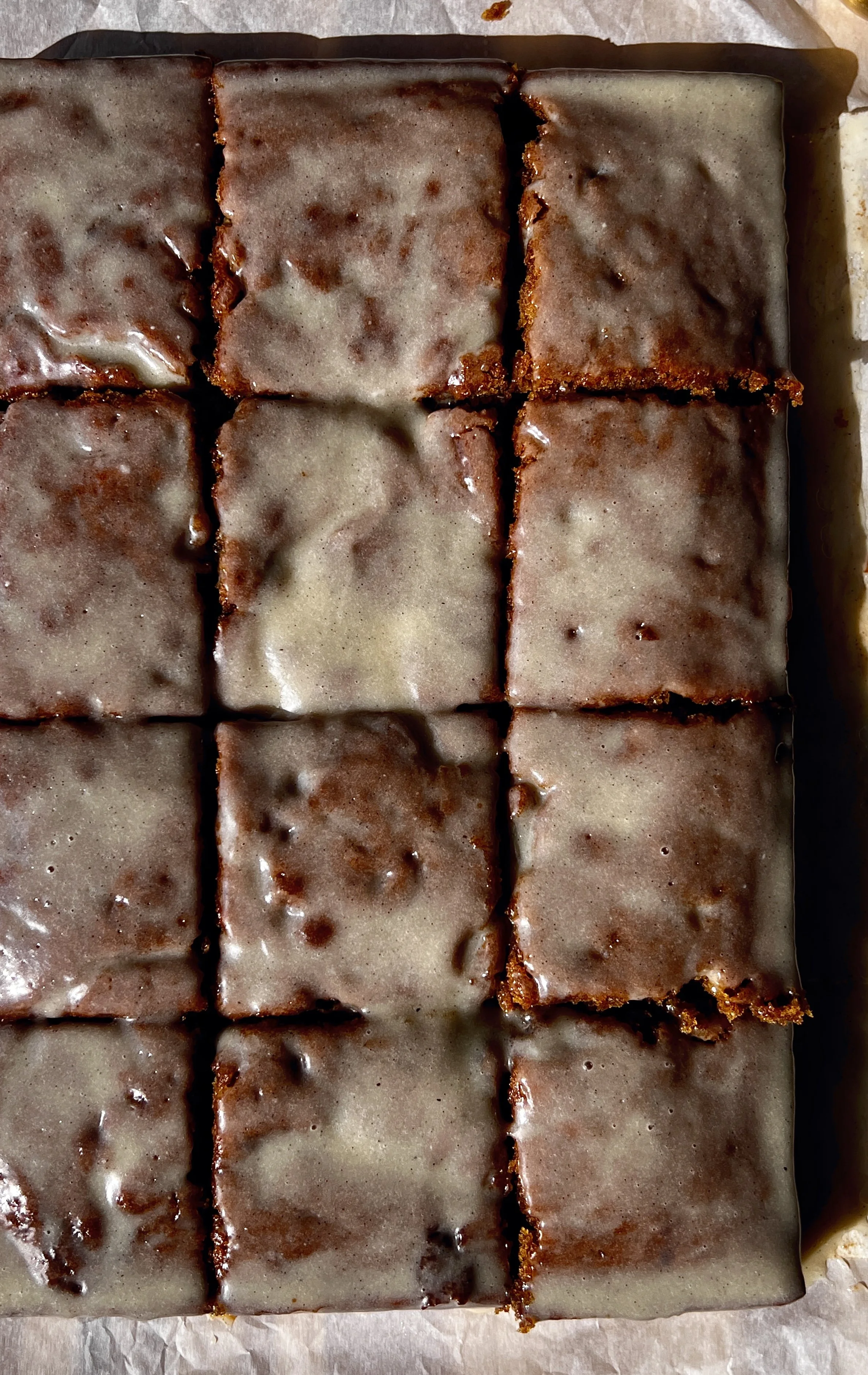 Slice of pumpkin honey bun cake showing the soft tender spiced pumpkin crumb with a cinnamon brown sugar swirl throughout and a honey cream cheese glaze blanket melting over the top.