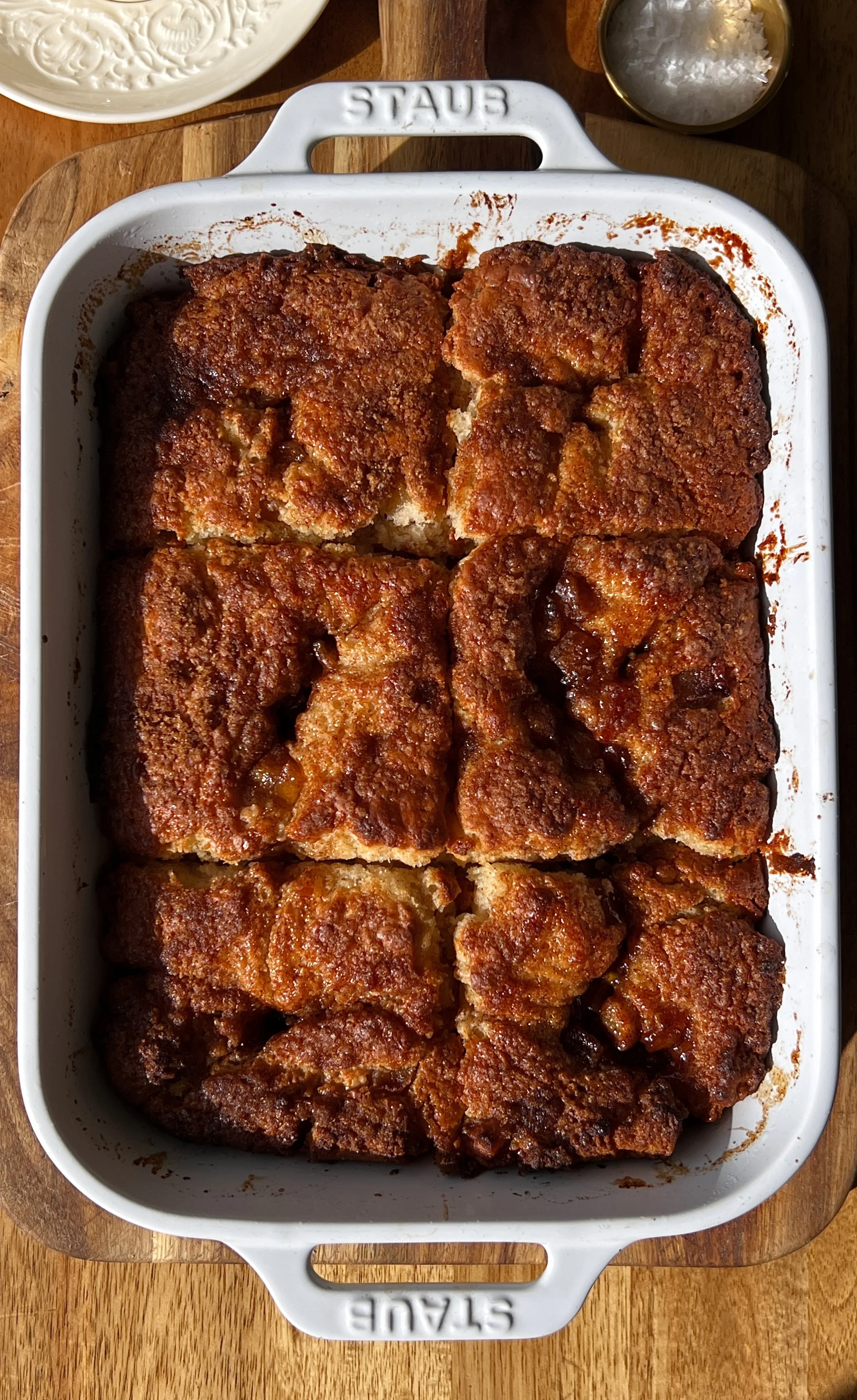Apple fritter butter swim biscuits with a warm homemade apple filling and cinnamon brown sugar topping baked until perfectly golden served warm with a pat of butter and a hot cup of coffee.