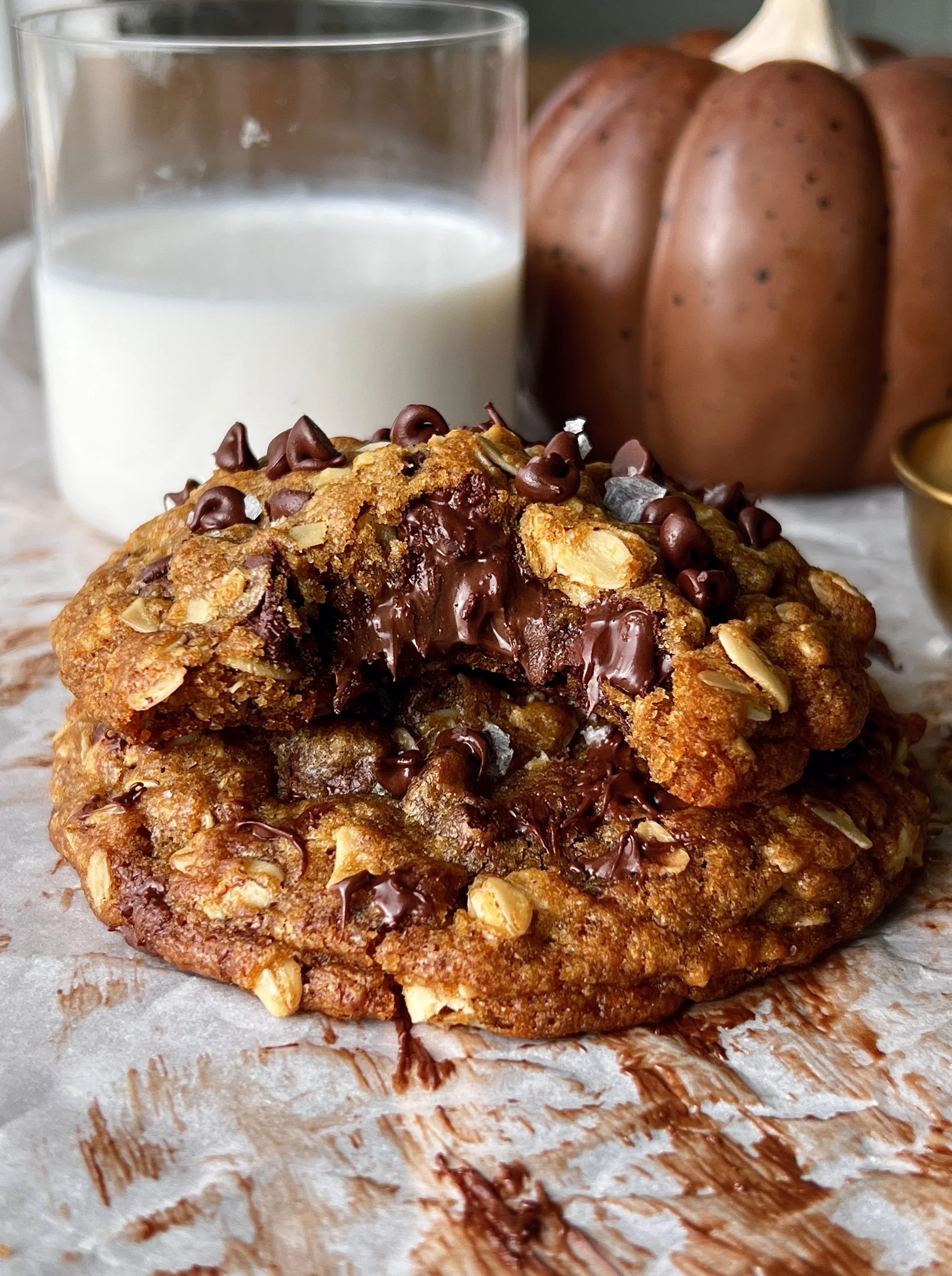 Soft and gooey Nutella stuffed pumpkin oatmeal cookies with brown butter perfectly crisp golden edges melty chocolate chips and a gooey Nutella center served warm with a sprinkle of flaky sea salt and a cold glass of milk.