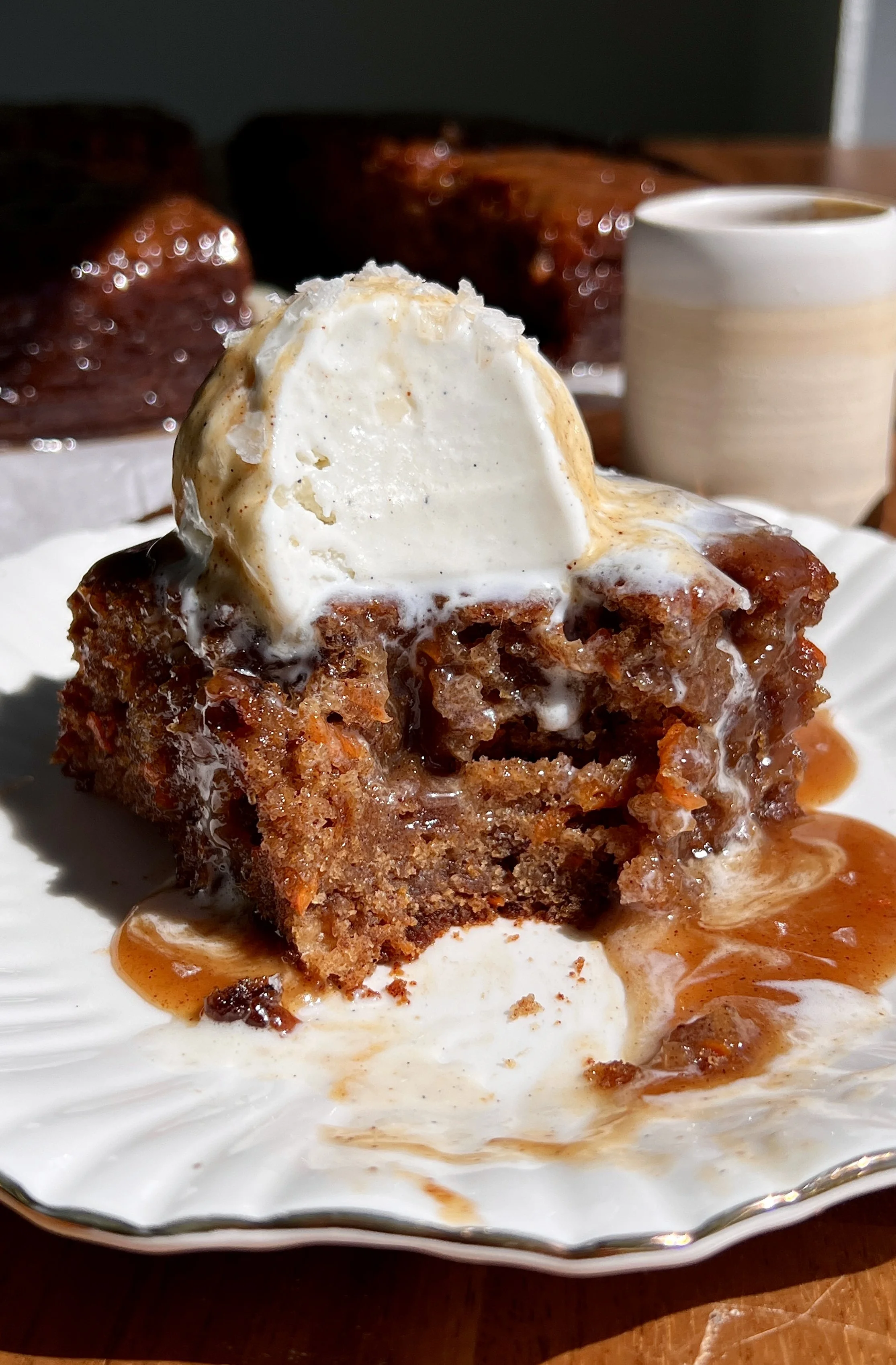 Warm carrot cake sticky toffee pudding served with spiced toffee sauce, vanilla ice cream, and flaky sea salt.
