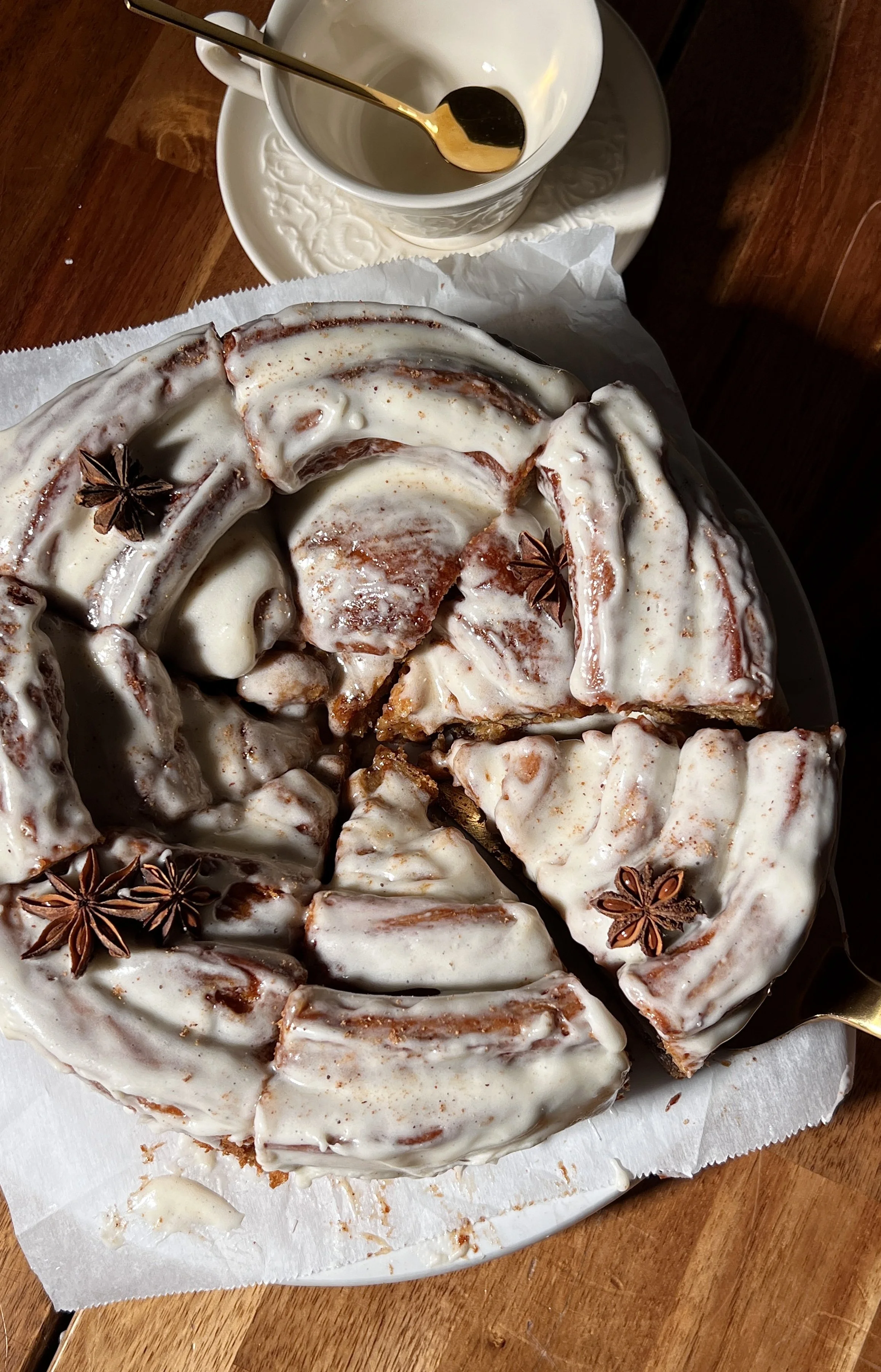 Close-up of a giant gingerbread cinnamon roll showing its soft, gooey center and cream cheese frosting.