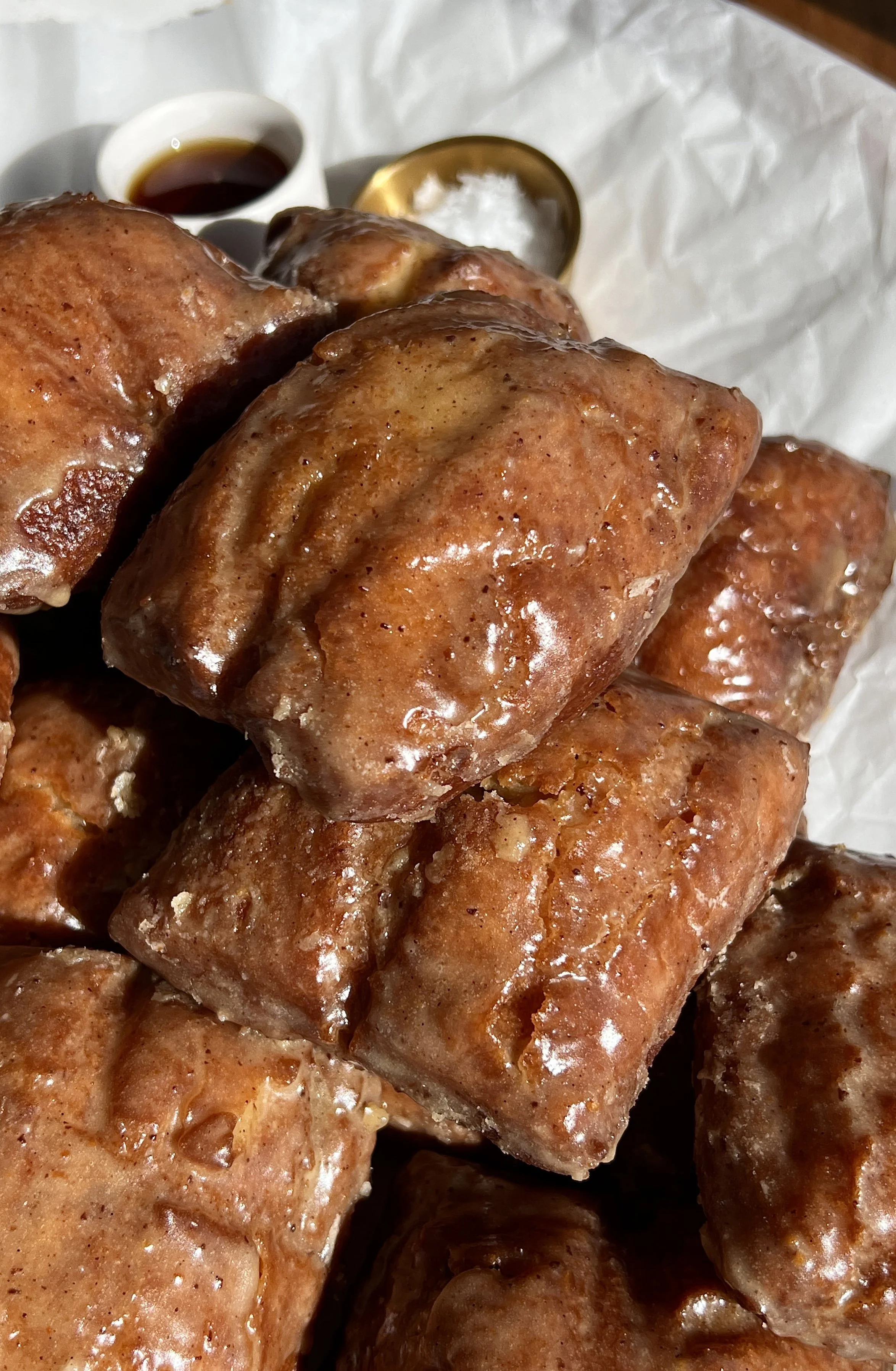 Old-fashioned buttermilk donut bars glazed with brown butter maple vanilla bean icing.