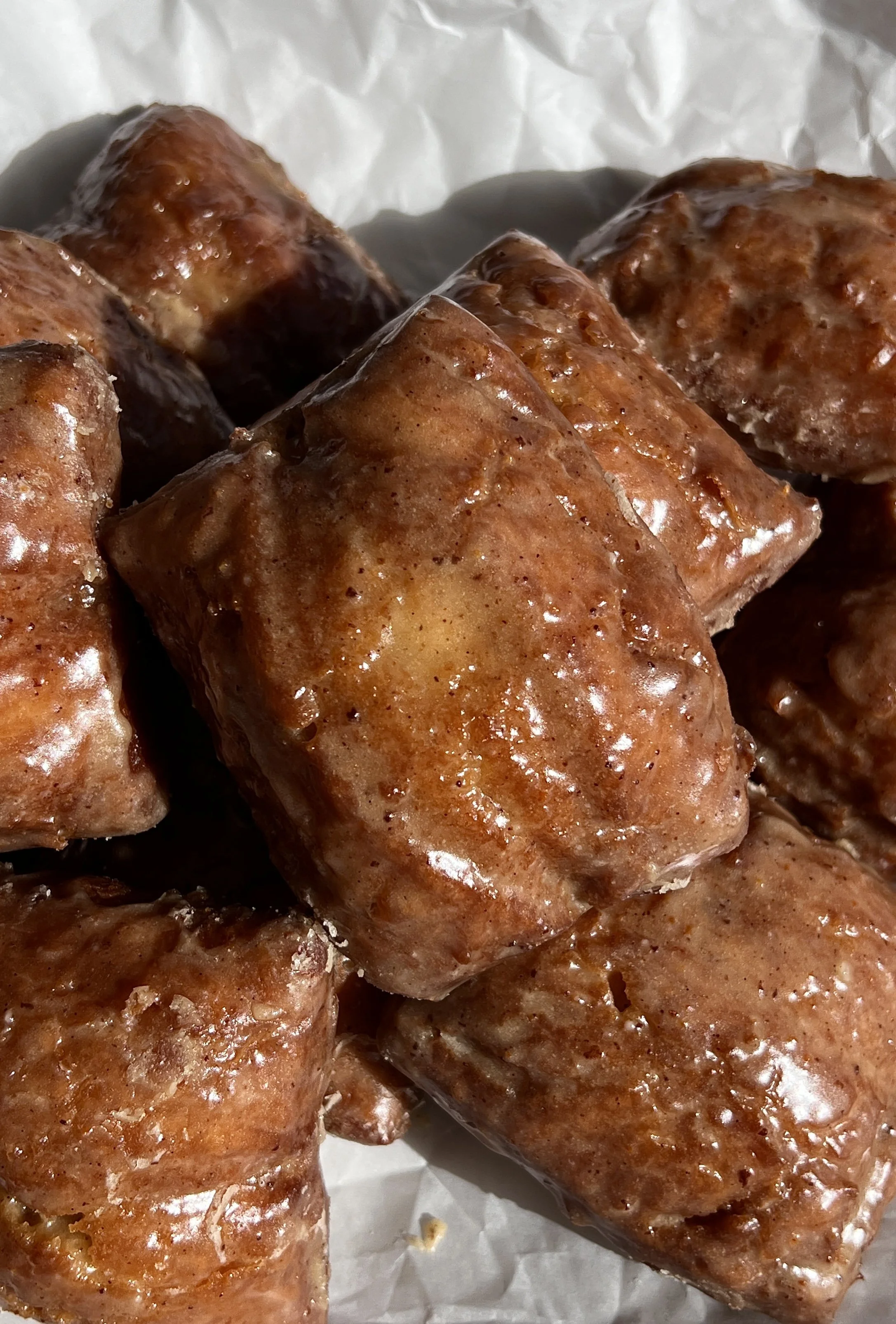 Old-fashioned buttermilk donut bars glazed with brown butter maple vanilla bean icing.
