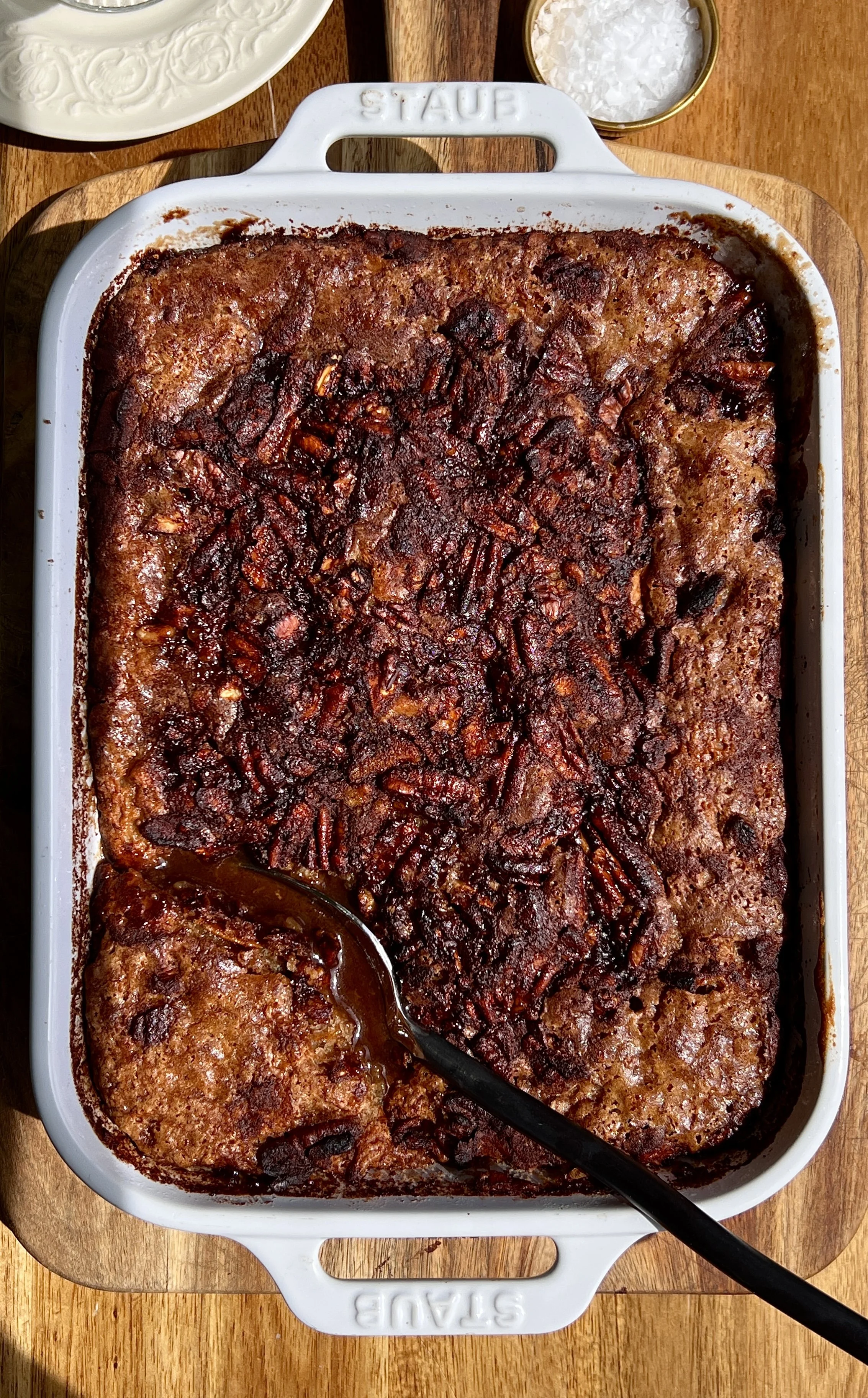 Close-up of self-saucing banana pudding cake with gooey syrupy bottom and soft golden cake top.