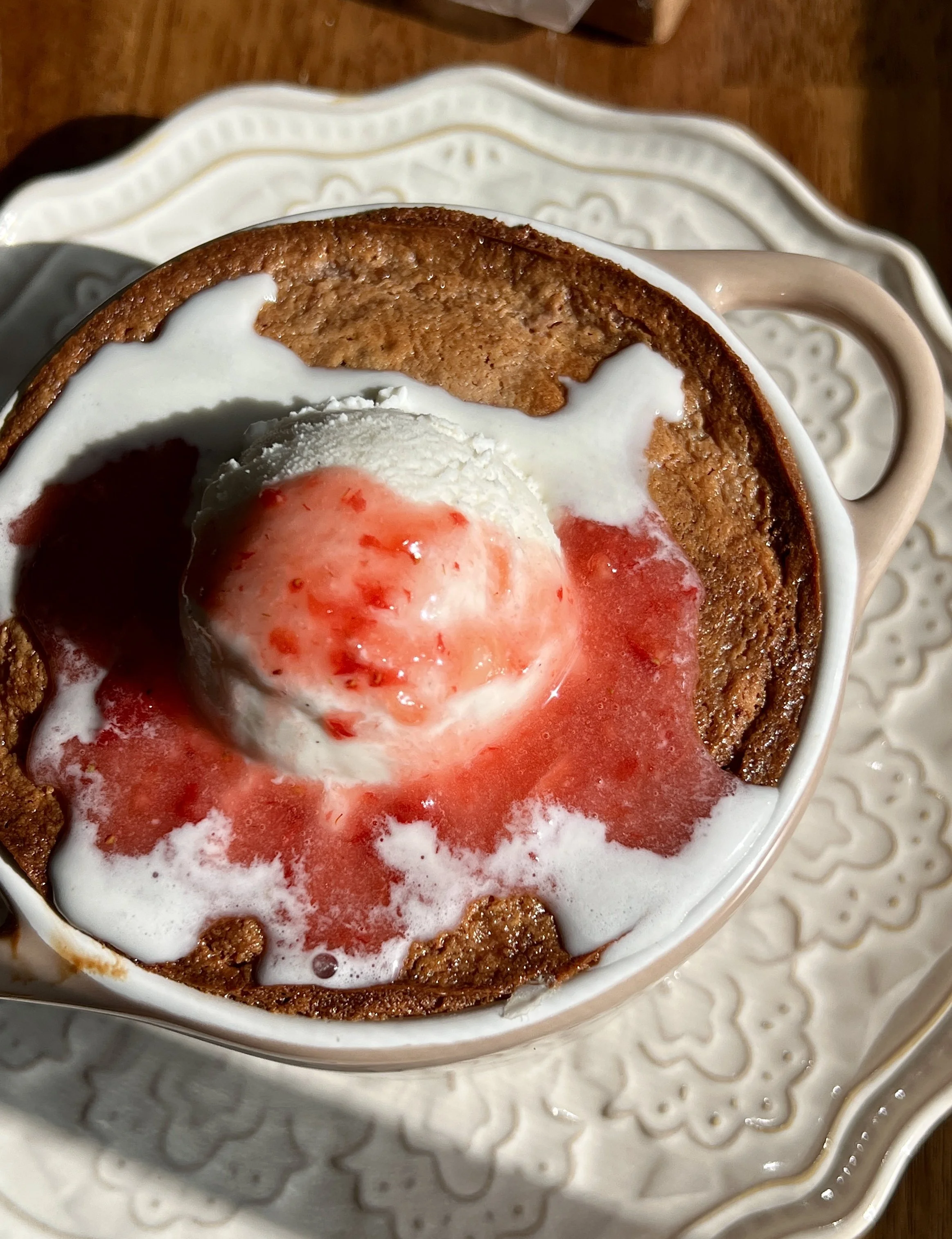 Warm strawberry gooey butter cakes for two, featuring a soft strawberry butter cake base filled with a gooey strawberry cream cheese filling, and served with a scoop of vanilla ice cream for a deliciously creamy dessert.