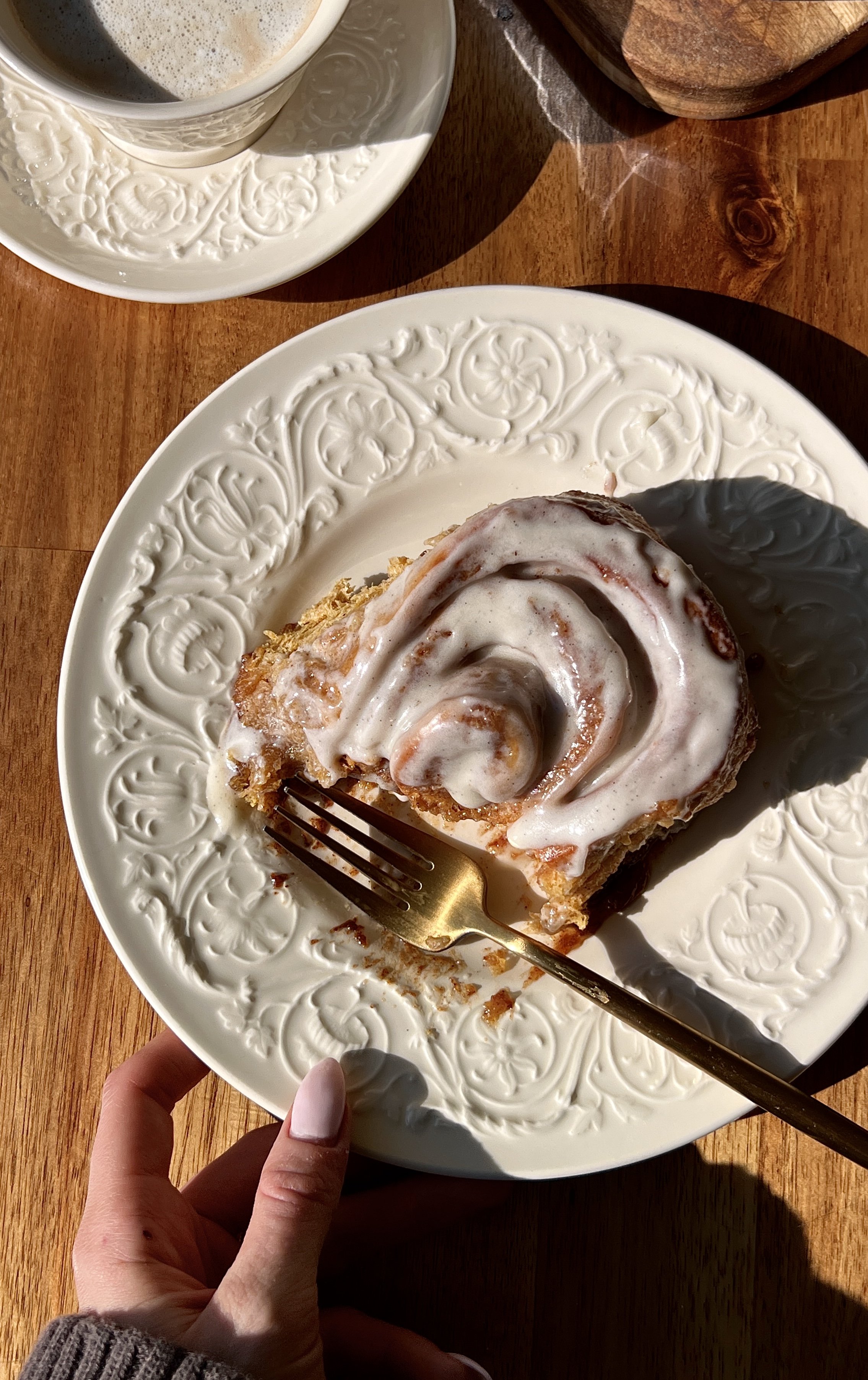 Soft and fluffy homemade pumpkin cinnamon rolls with beautifully golden caramelized edges and a warming gooey pumpkin spice cinnamon filling finished with classic cream cheese frosting served warm with a hot cup of coffee.