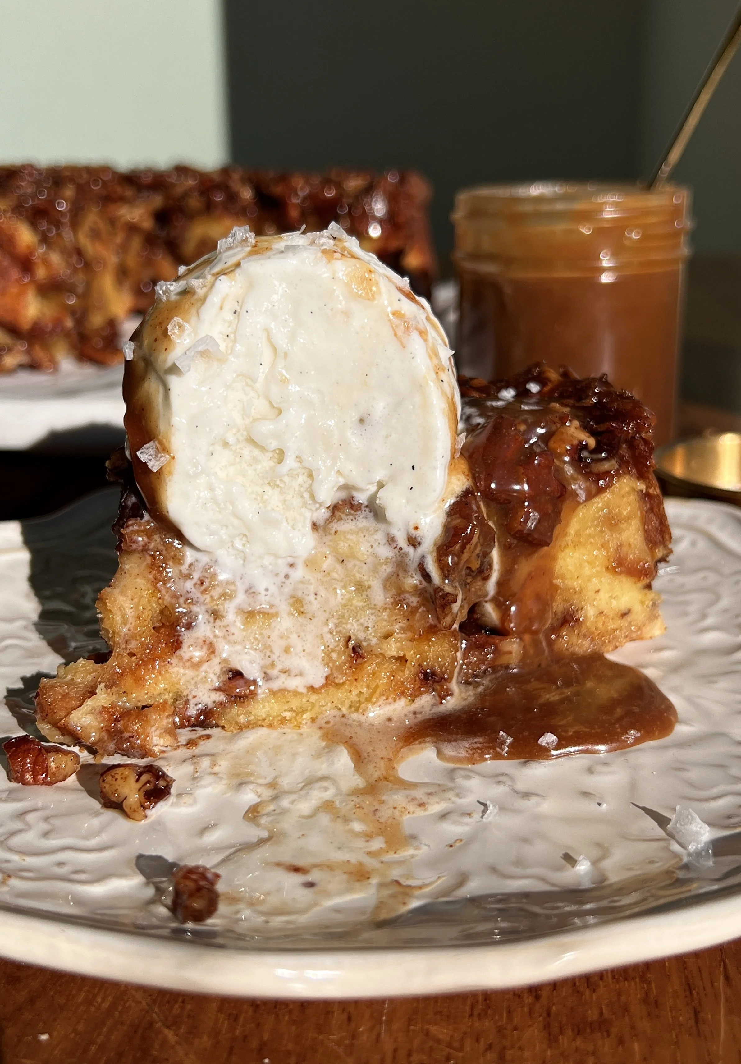 Close-up of pecan sticky bun bread pudding showing custardy brioche layers and sticky pecan filling.