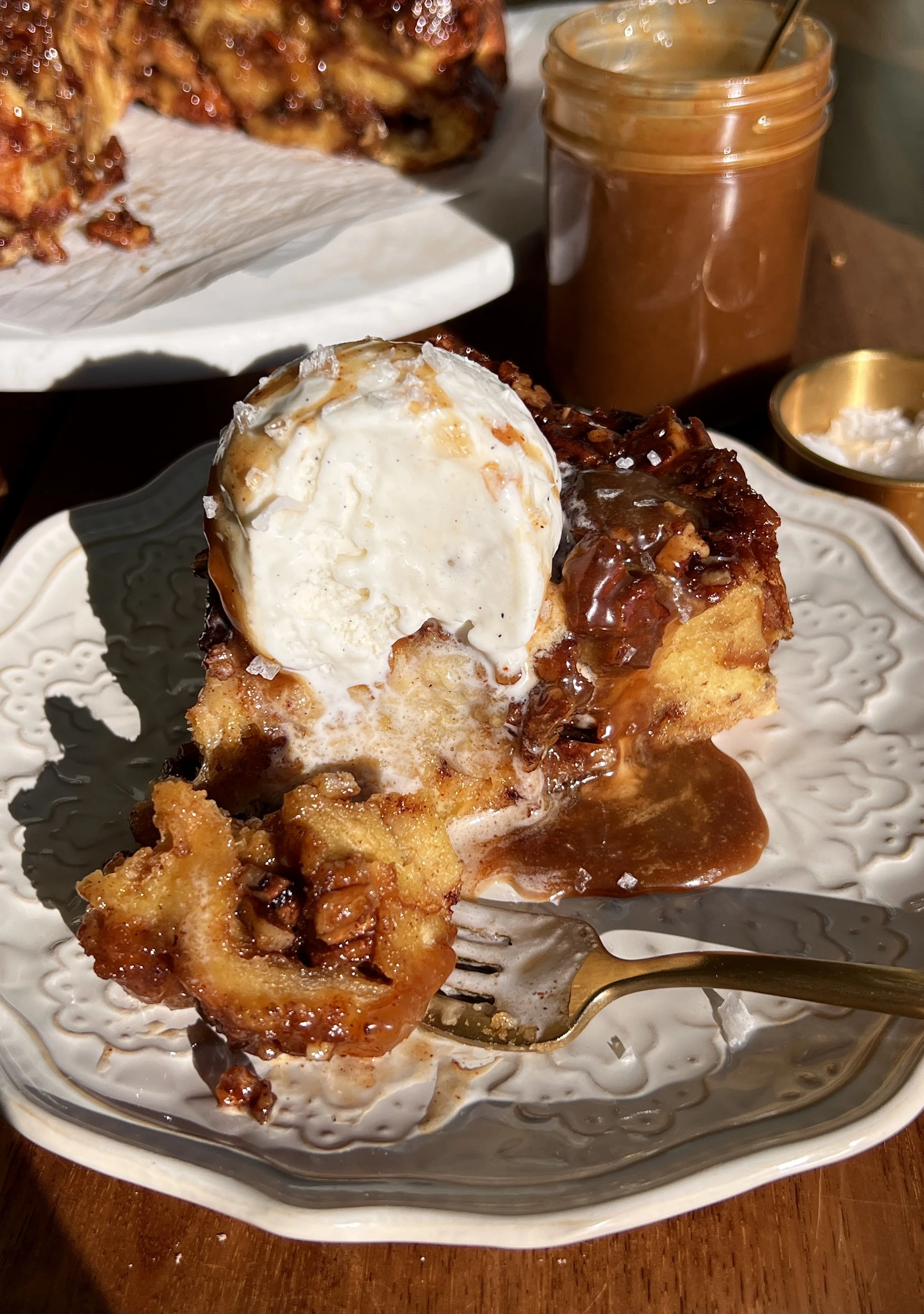 Pecan sticky bun bread pudding served warm with vanilla ice cream and flaky sea salt.