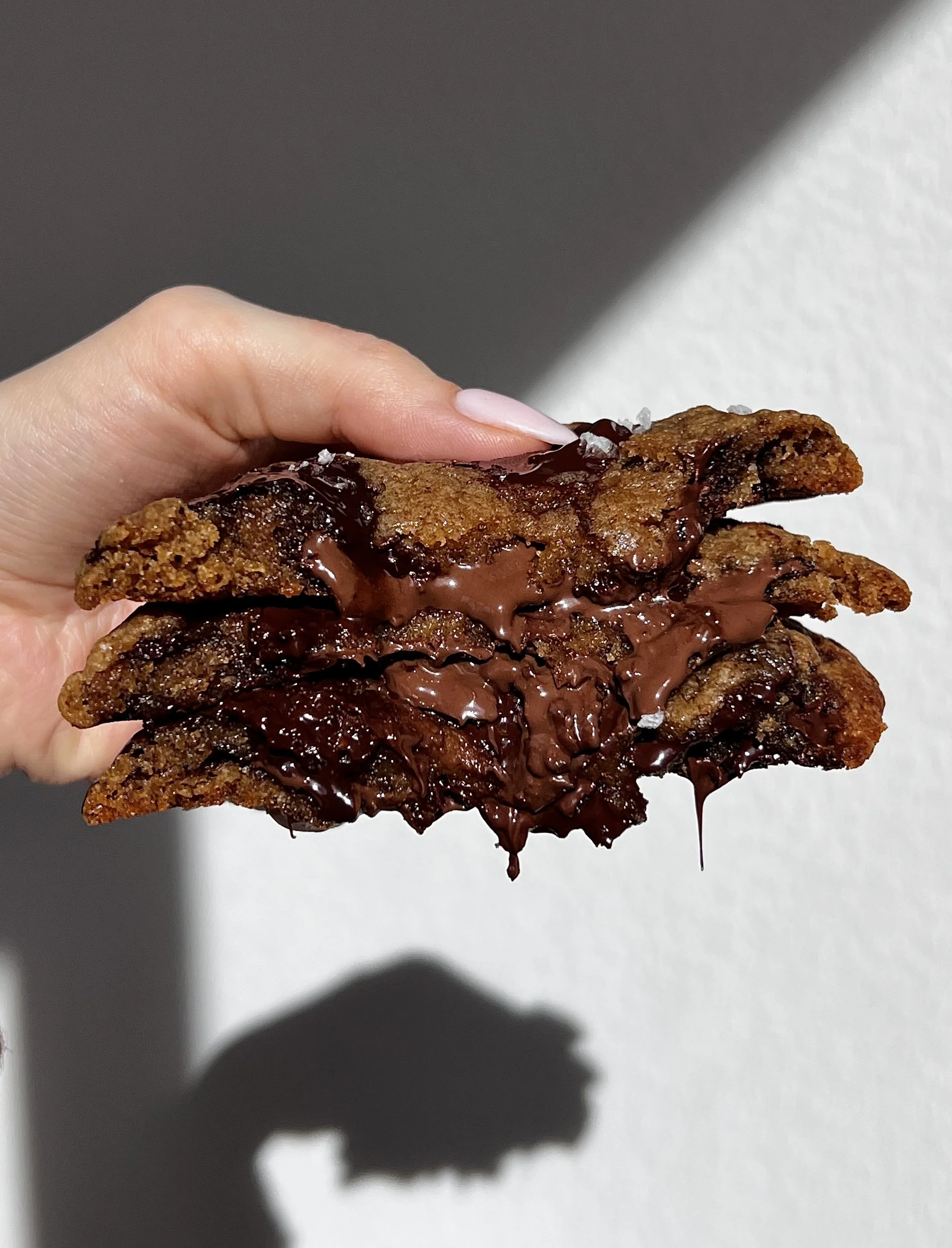 Soft and gooey Nutella stuffed banana bread cookies with golden crisp edges and melted chocolate chips.