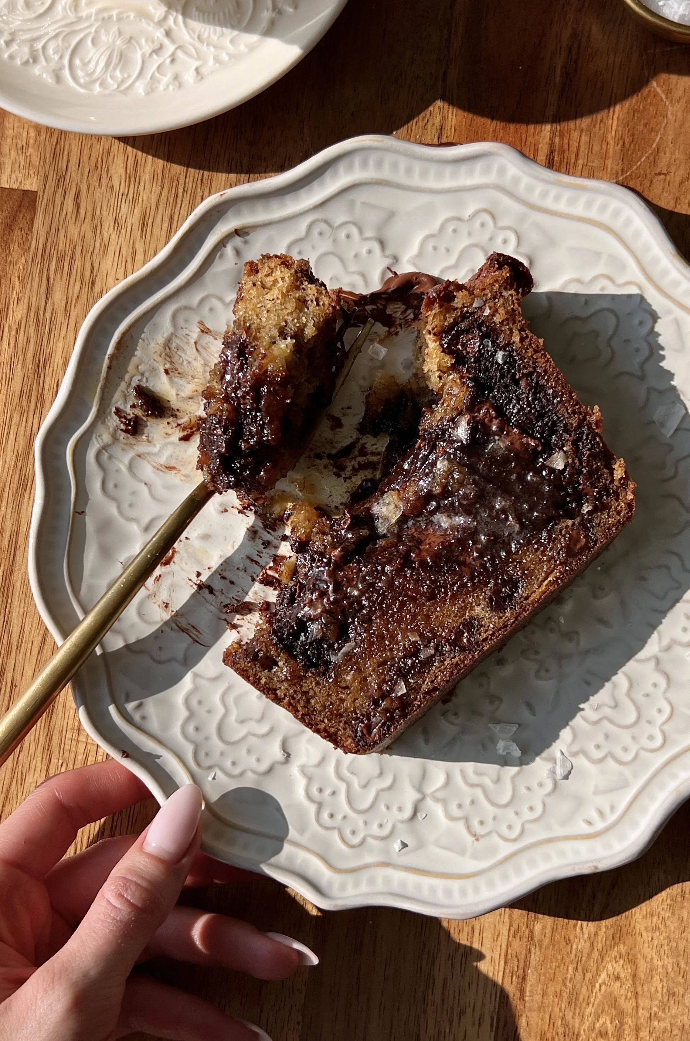 Soft and fluffy brownie stuffed banana bread with brown butter and a beautifully golden exterior served warm with a pat of butter, a sprinkle of flaky sea salt, and a hot cup of coffee.