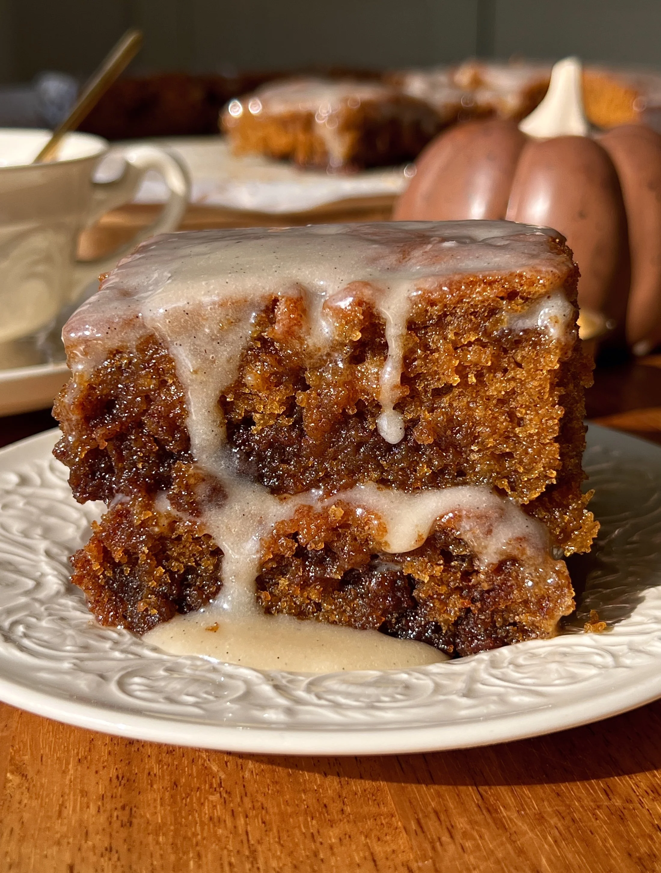 Pumpkin honey bun cake with a cinnamon brown sugar swirl and honey cream cheese glaze blanket served warm.