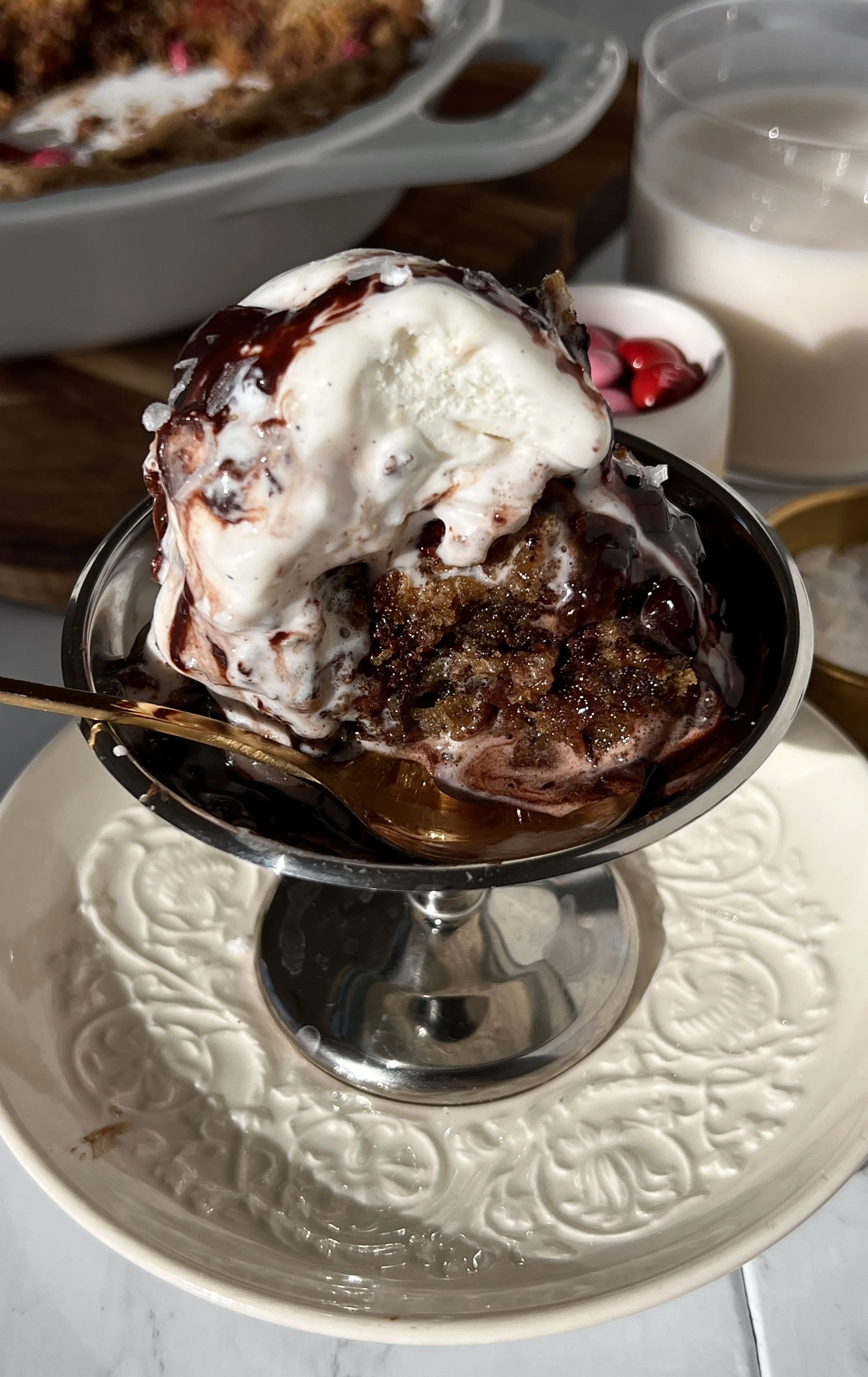 Warm scoopable brown butter chocolate chip cookies served with vanilla ice cream, flaky sea salt, and hot fudge sauce.