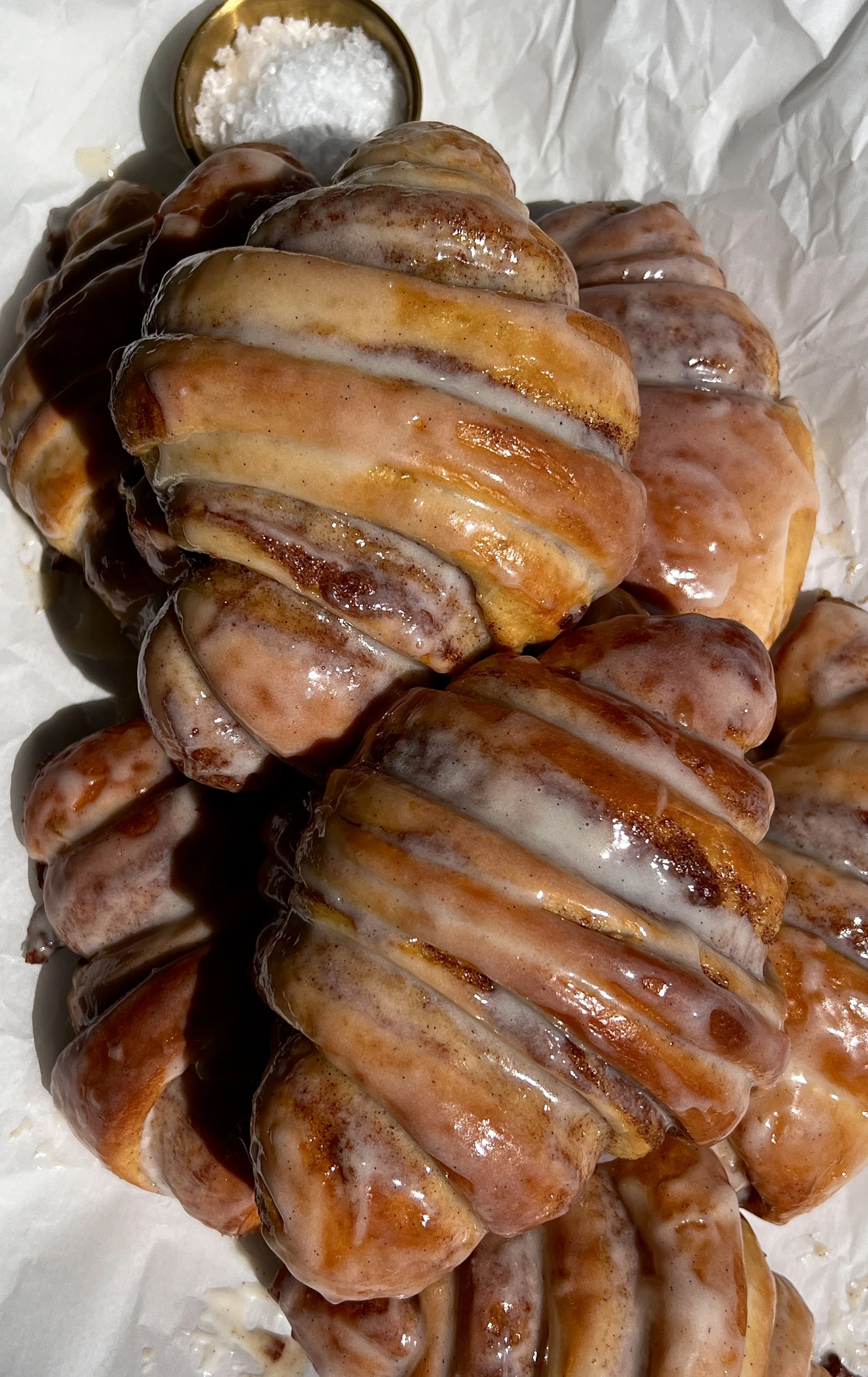 Cinnamon roll croissants topped with cream cheese glaze and served warm.