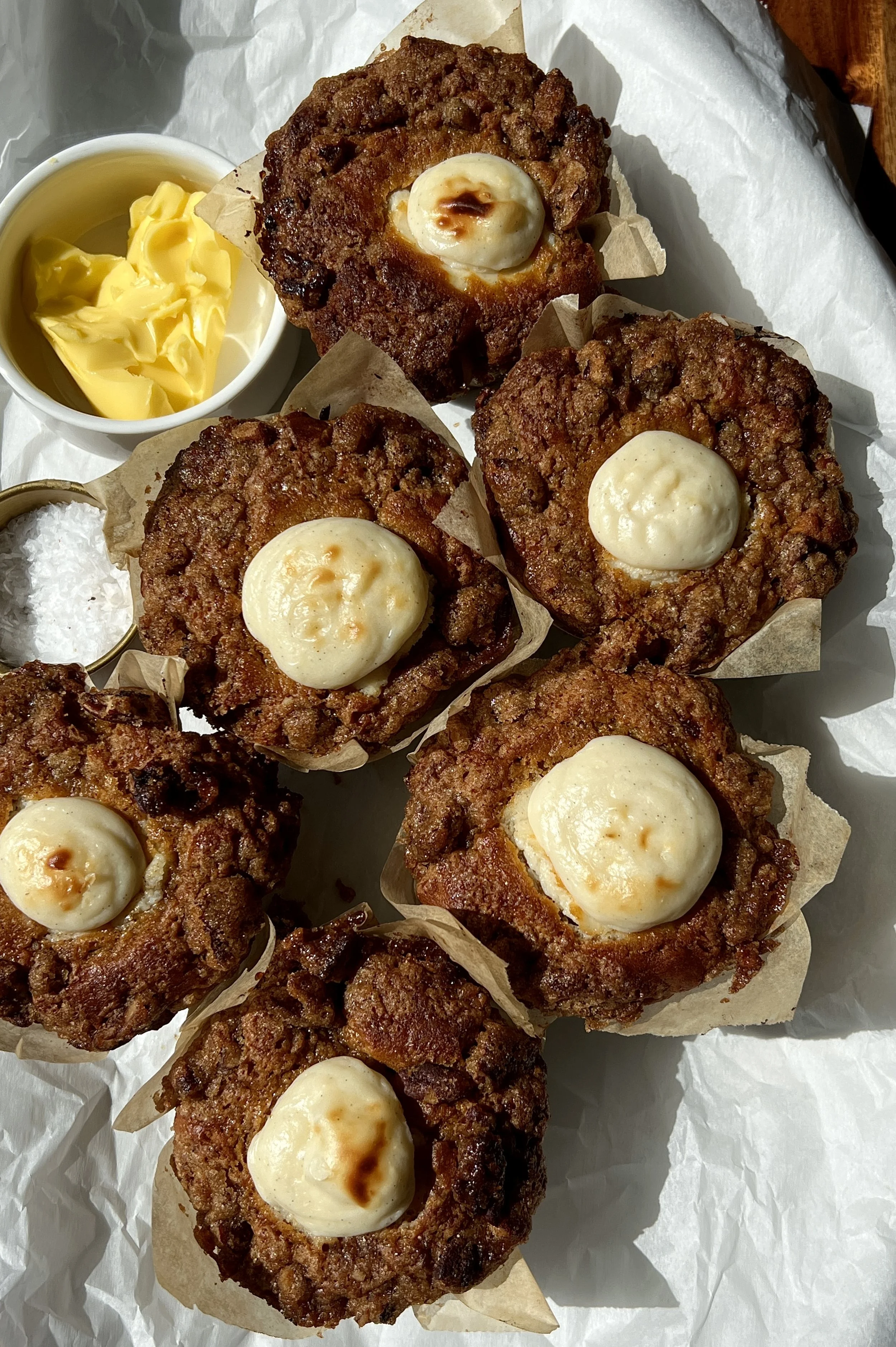 Close-up of Brown Butter Sweet Potato Cream Cheese Muffins topped with brown sugar pecan streusel