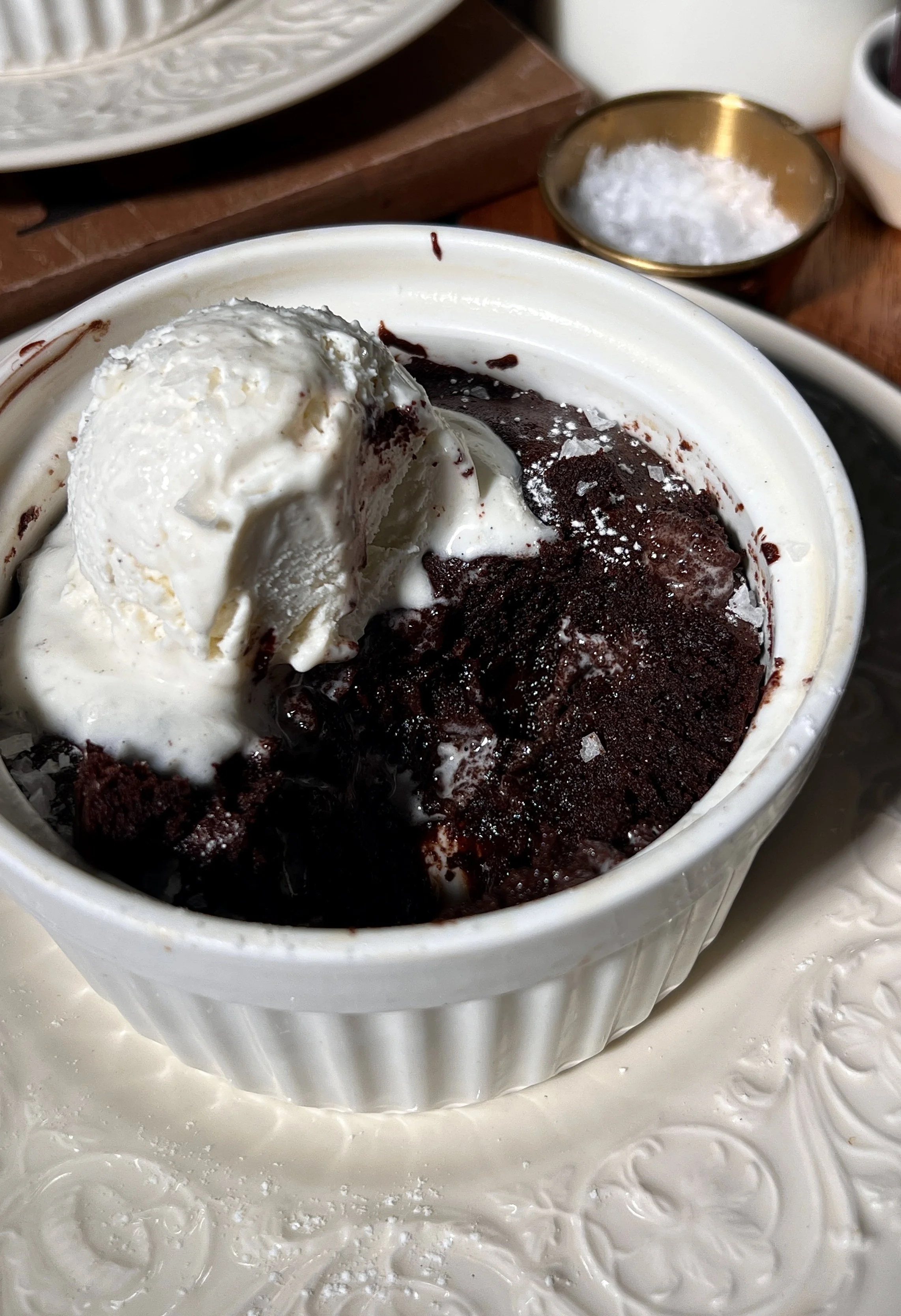Close-up of flourless chocolate cake showing a fudgy interior and crackly chocolate top.